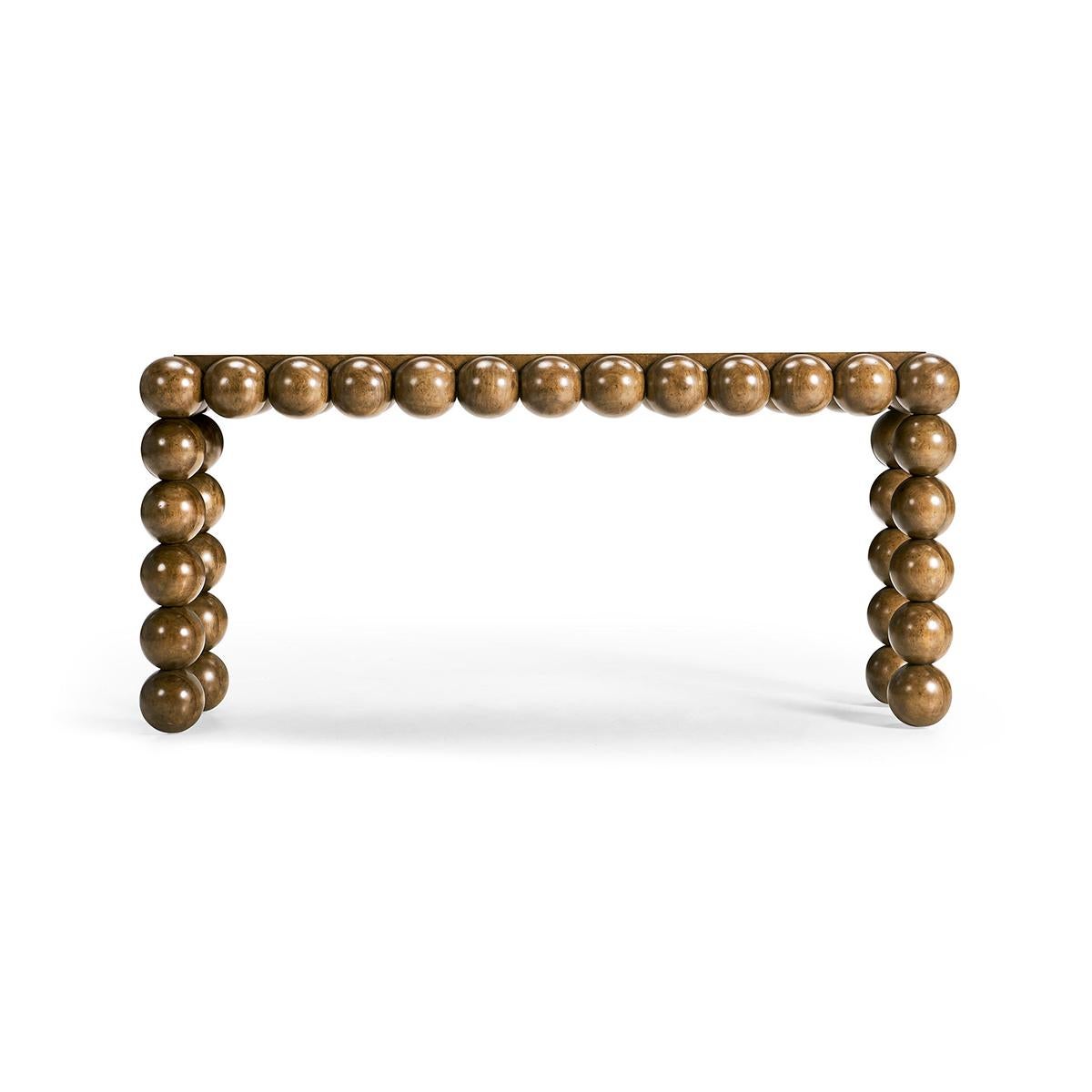 With its captivating spheres and luxurious finish, it becomes the centerpiece that seamlessly combines modern elegance and sophistication. The table's solid wood-stacked orbs form a charismatic foundation that fuses art and functionality. These orbs