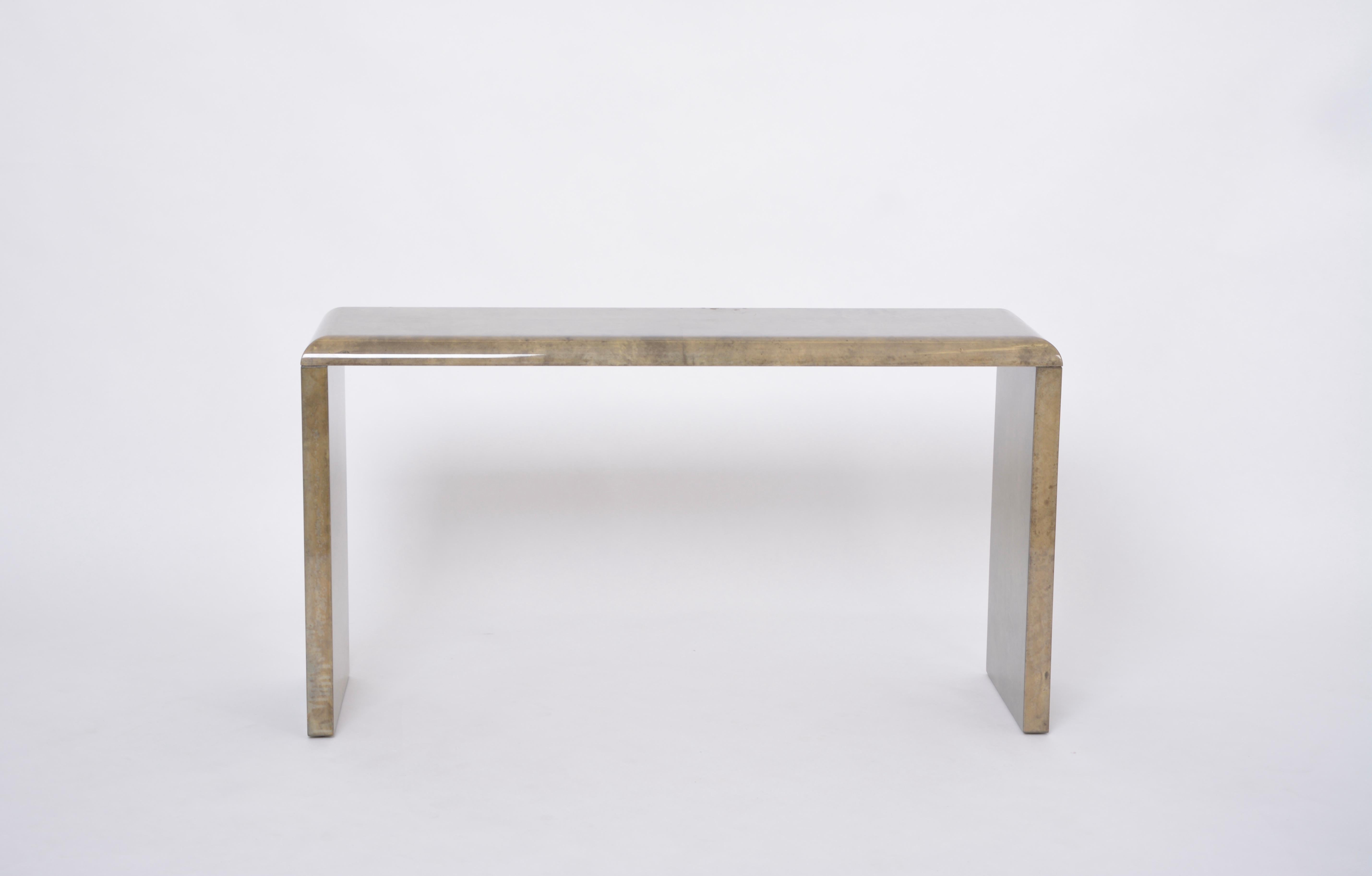 Mid-Century Modern Console Table Made of Laquered Goat Skin by Aldo Turabdesigned by Aldo Tura and produced in Italy approximately in the 1970s.
The console table has a wood structure which is covered in Aldo Tura's signature style parchment in
