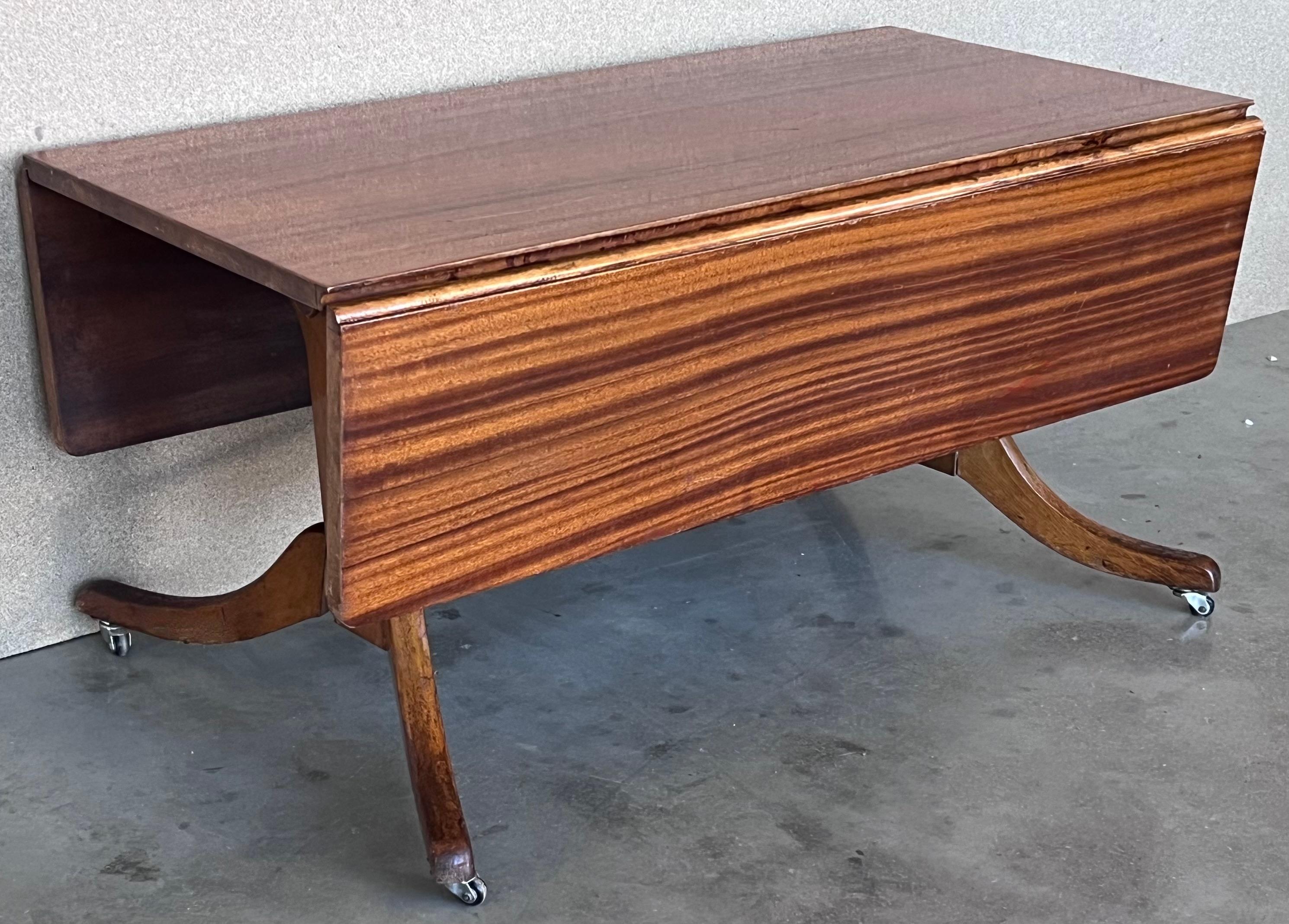 Mid-Century Modern convertible liftable coffee dining table with folding leafs. 

You can use the table like a coffee table or a dinning room table. The table has a modern patented mechanism of this period that allows to up and down the table,