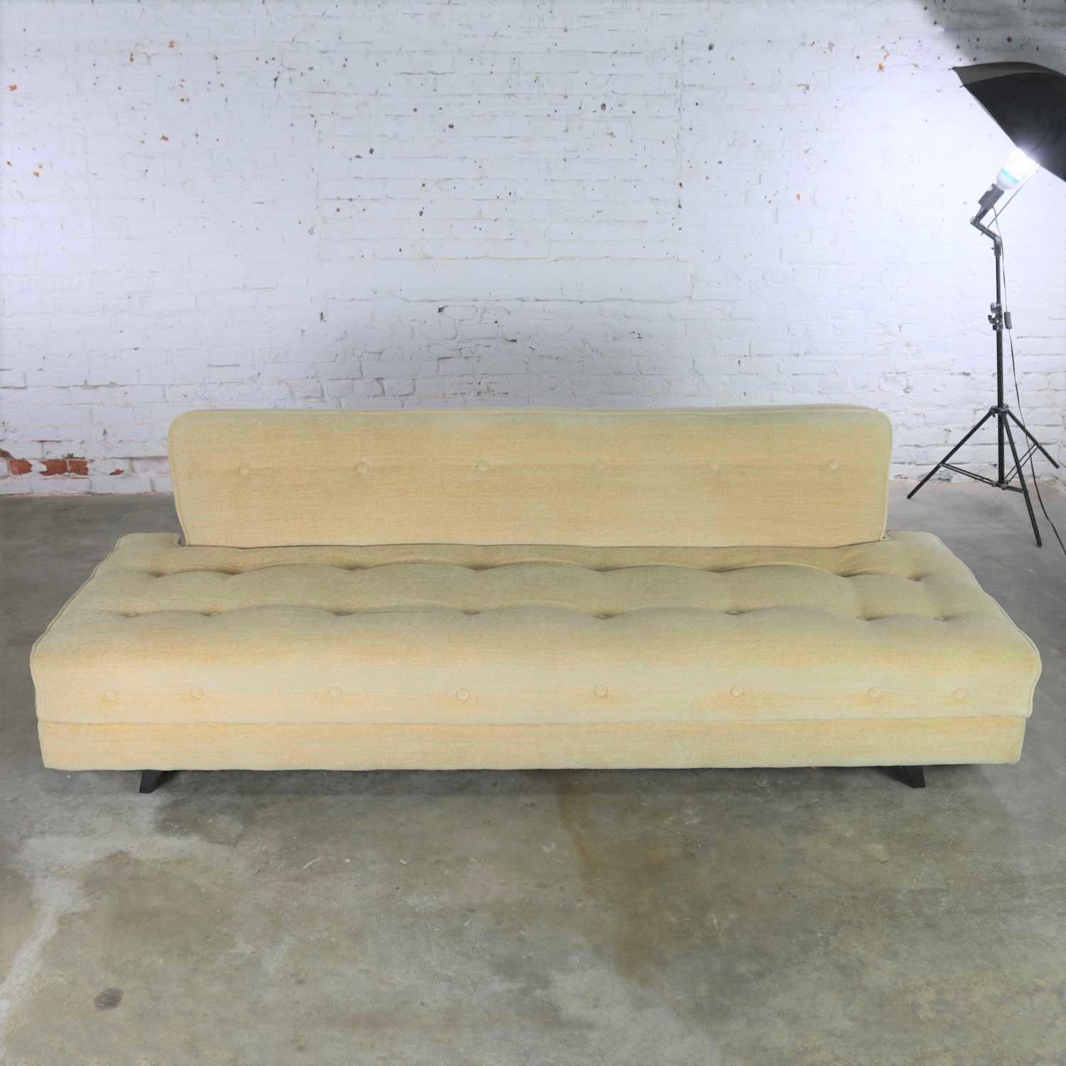 Handsome and versatile Mid-Century Modern convertible sofa bed in oatmeal colored mohair-like fabric with button detail. There is storage in the bottom for bedding. It is in wonderful vintage condition, we think it was reupholstered at some point