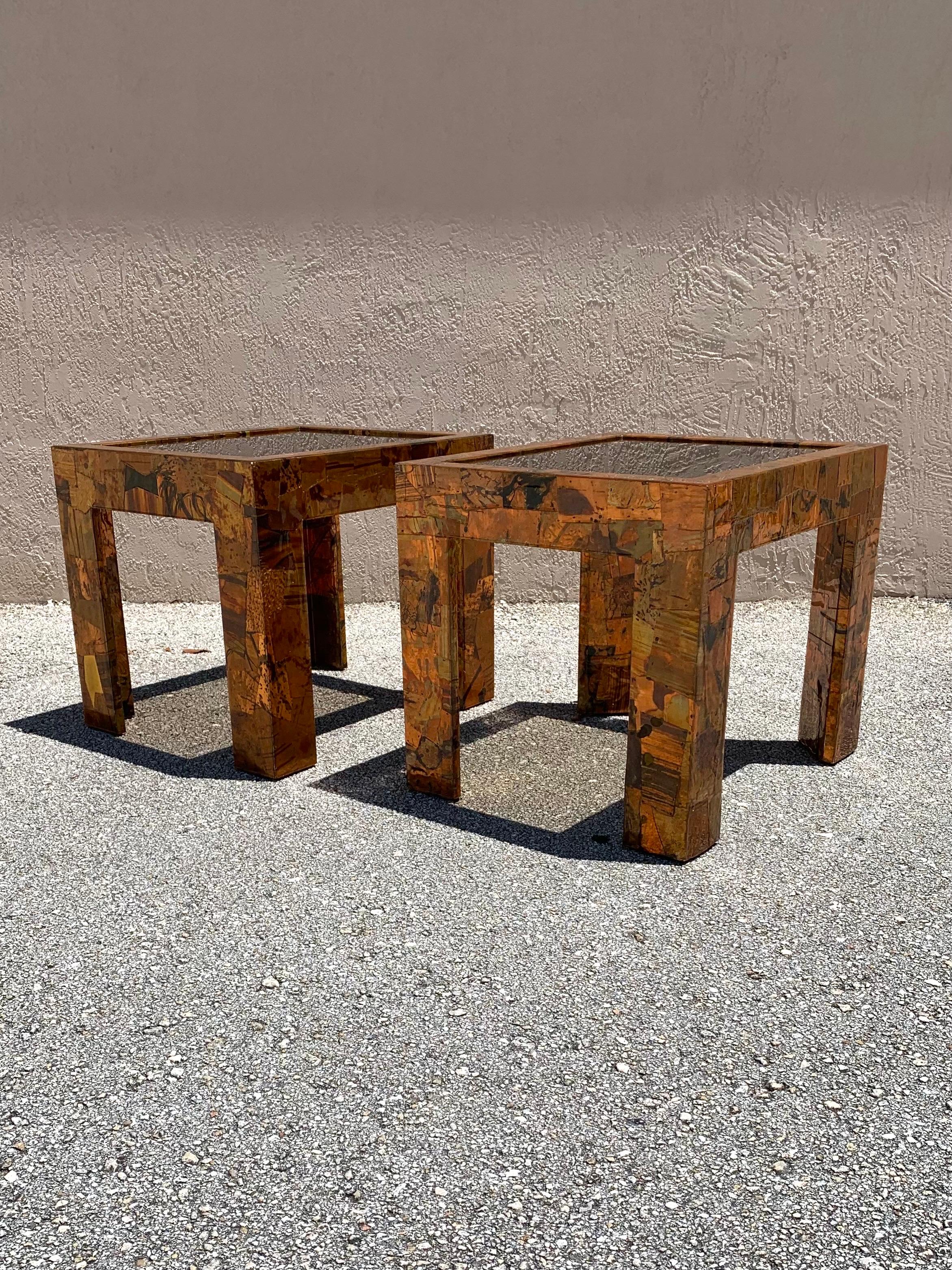 Beautiful pair of studio made copper and brass coffee tables. High end materials and finish made to have a clean yet brutalist type flair. The artist used different pieces of textured and patinated copper and clean brass hand picked and hand cut to