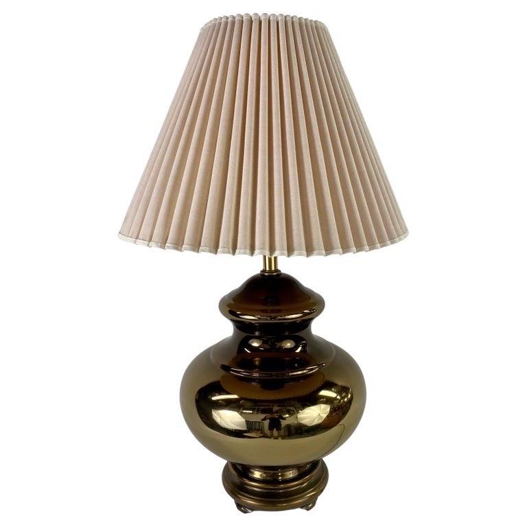A pair of Mid-Century Modern table lamps crafted in polished copper, each with a bold gourd-shaped body that reflects light with a warm, metallic glow. The rich copper finish lends the lamps both sculptural presence and a sense of timeless elegance,