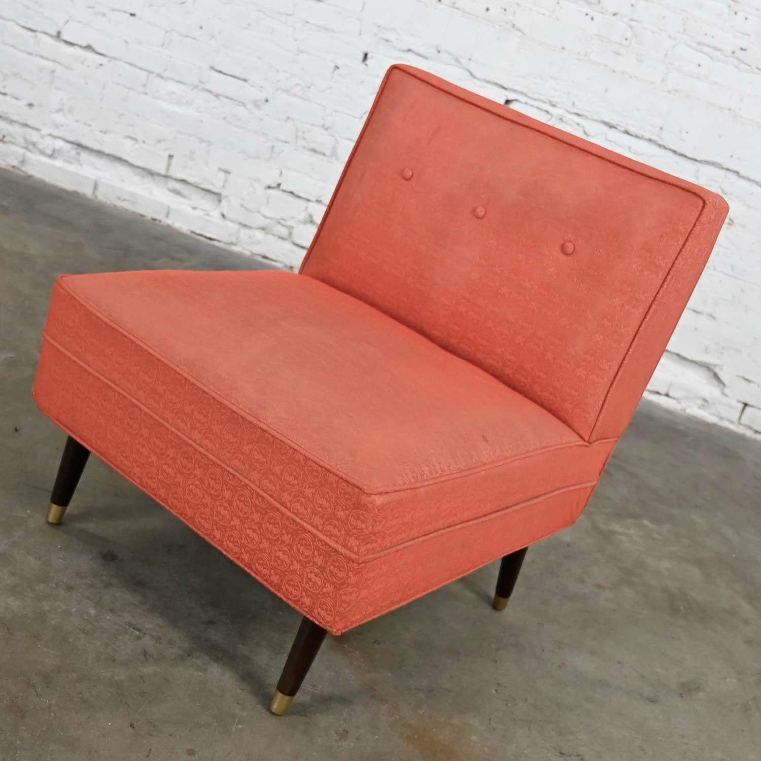 Stunning Mid-Century Modern coral vinyl faux leather slipper chair with tapered walnut-colored legs and brass painted sabots. Beautiful condition, keeping in mind that this is vintage and not new so will have signs of use and wear. The vinyl,