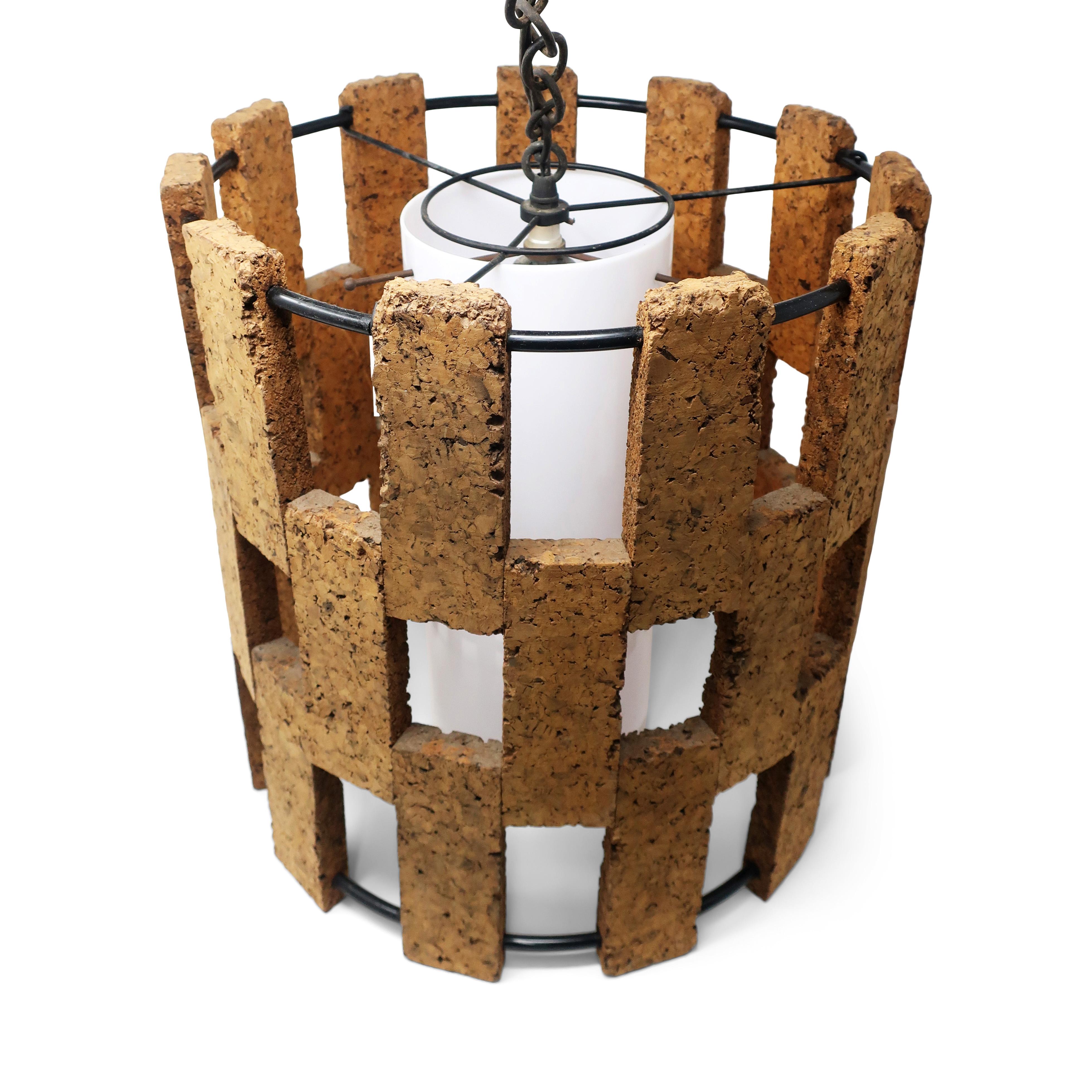 A lovely vintage cork swag lamp with alternating pieces of cork and open space held together by black metal wire, all surrounding an interior opaque white cylindrical diffuser. On/off switch is on the cord, which is threaded through a 20+ foot