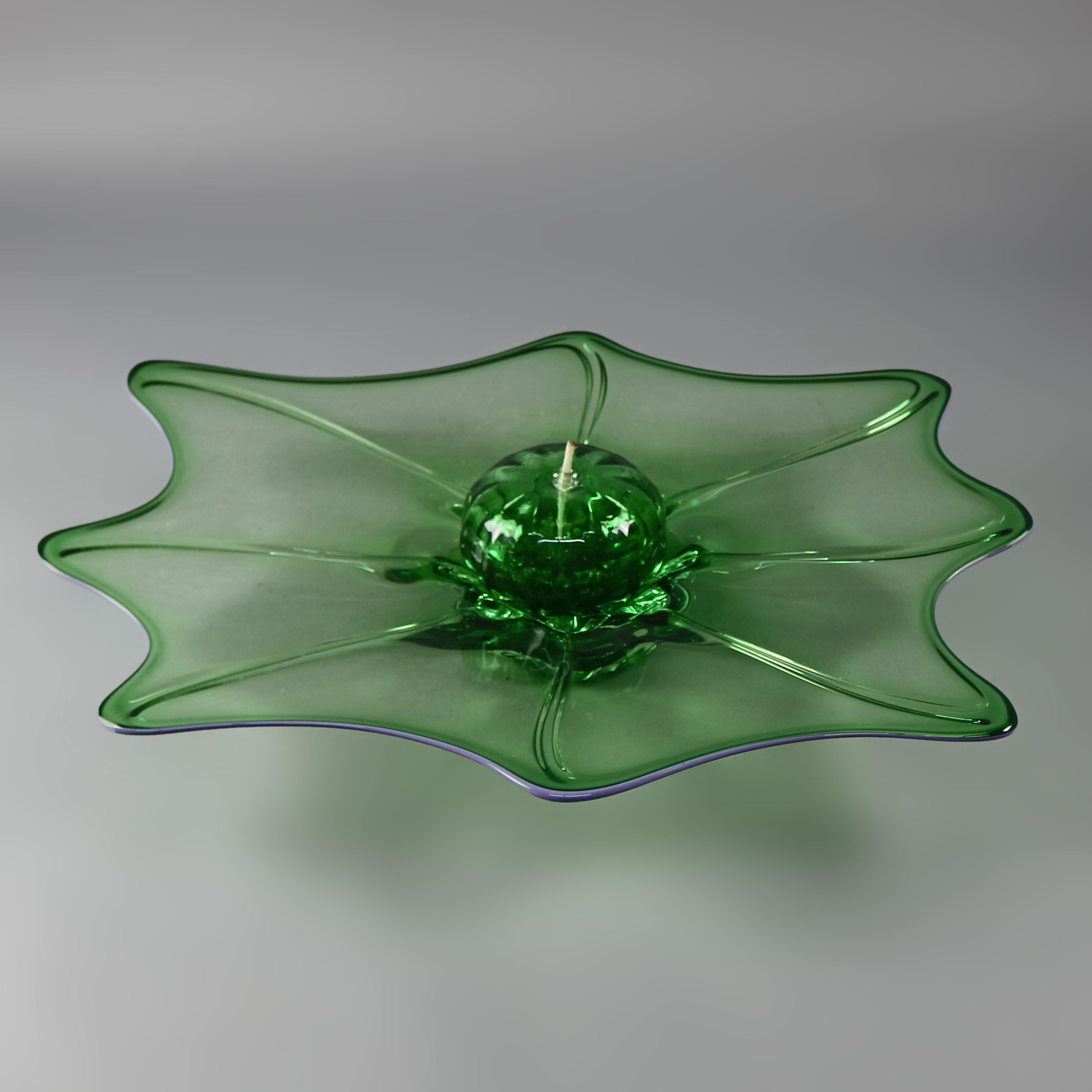 A Mid-Century Modern green Vitrix art glass center bowl with oil lamp offers free form rim with central glass oil font, signed on base as photographed, 20th century.

Measures: 5