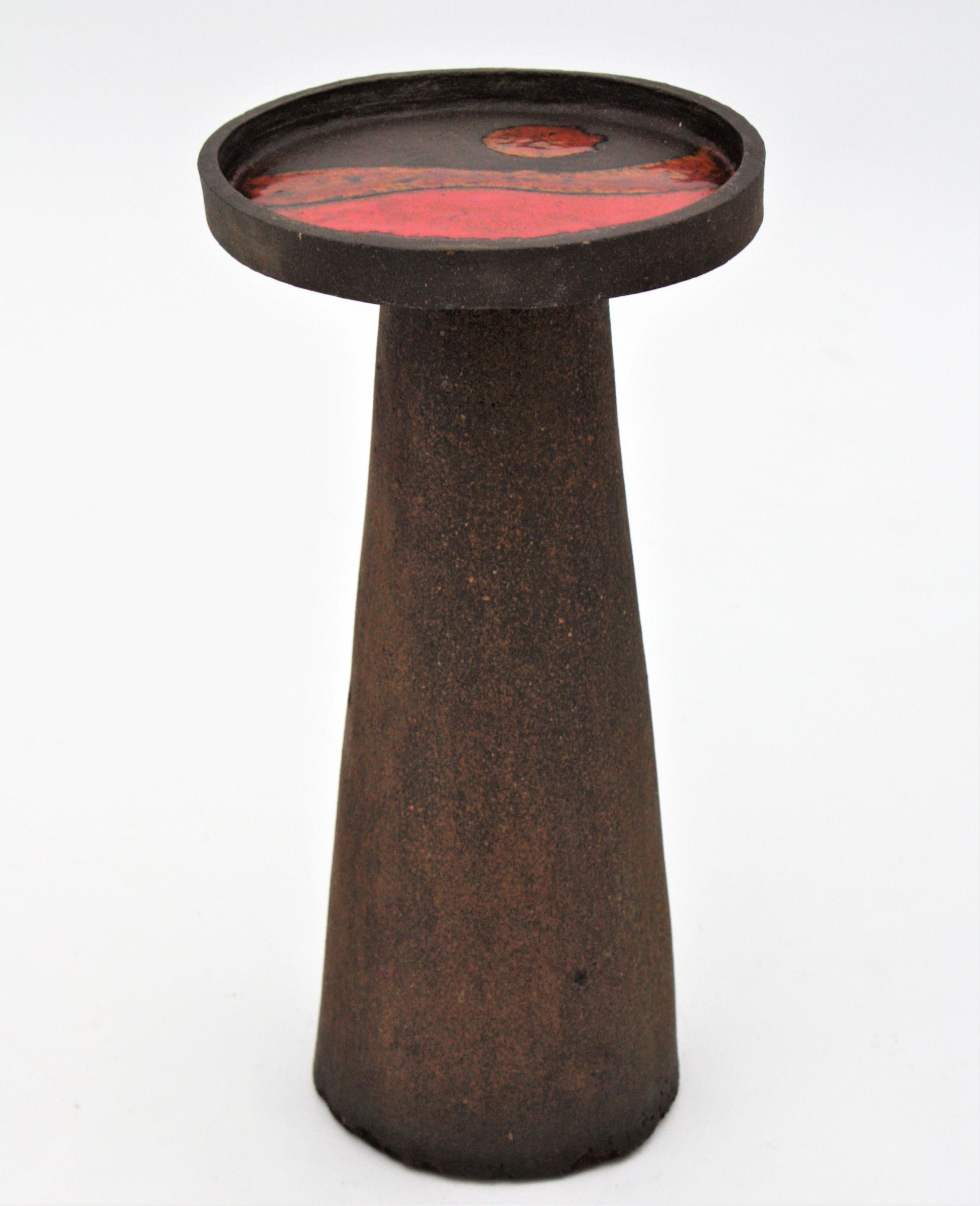 Handcrafted TOTEM Mid-Century Modern ceramic round table with abstract surreal sea landscape on the top. Spain, 1950s.
This sculptural TOTEM end table features an abstract surrealist sea landscape in red, orange and yellow colors on the top. This