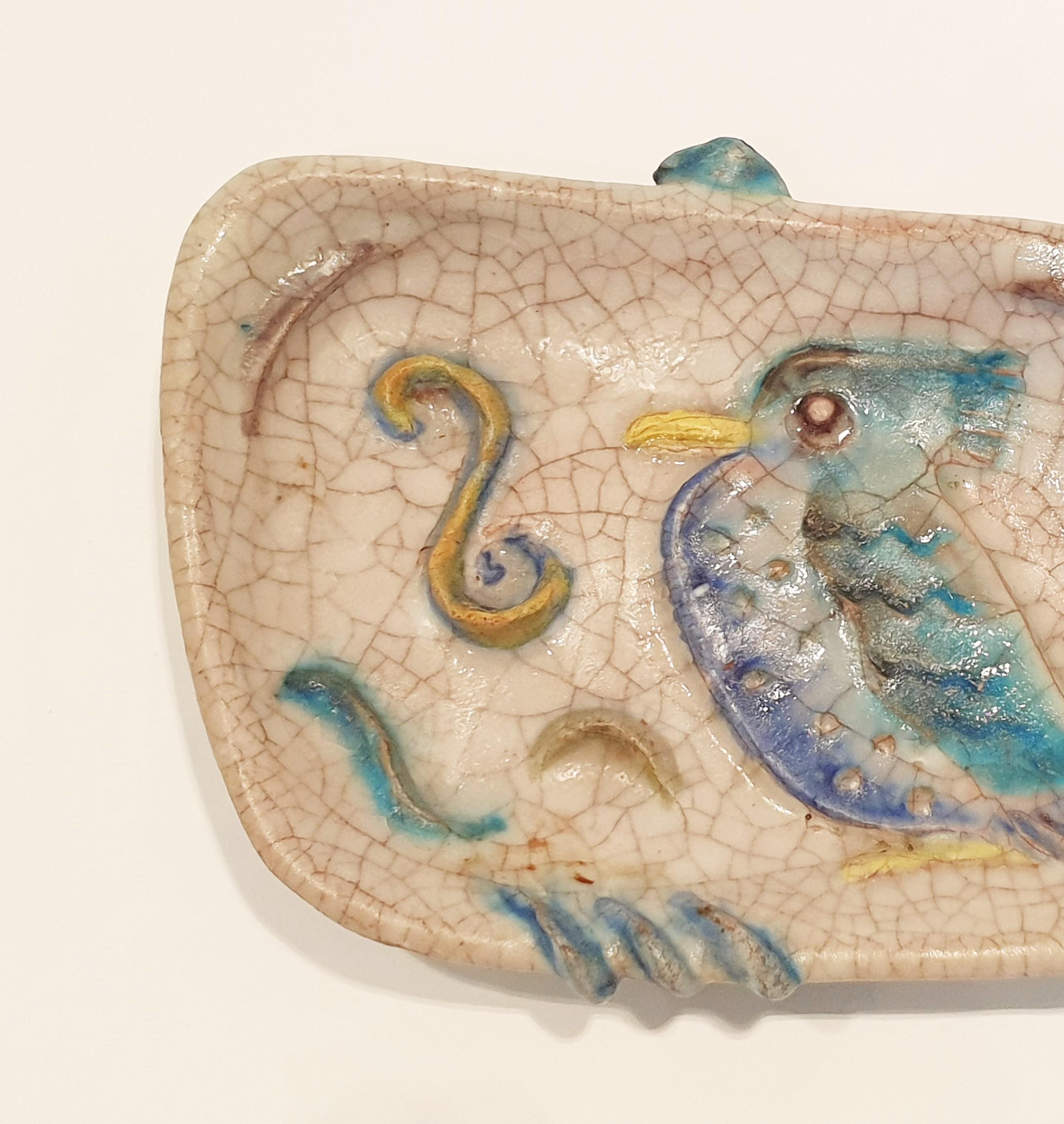 Colourful mid century, Italian ceramic dish with raised decoration of a bird in crackle glaze. Signed to the base Fantoni.
We have three dishes available.