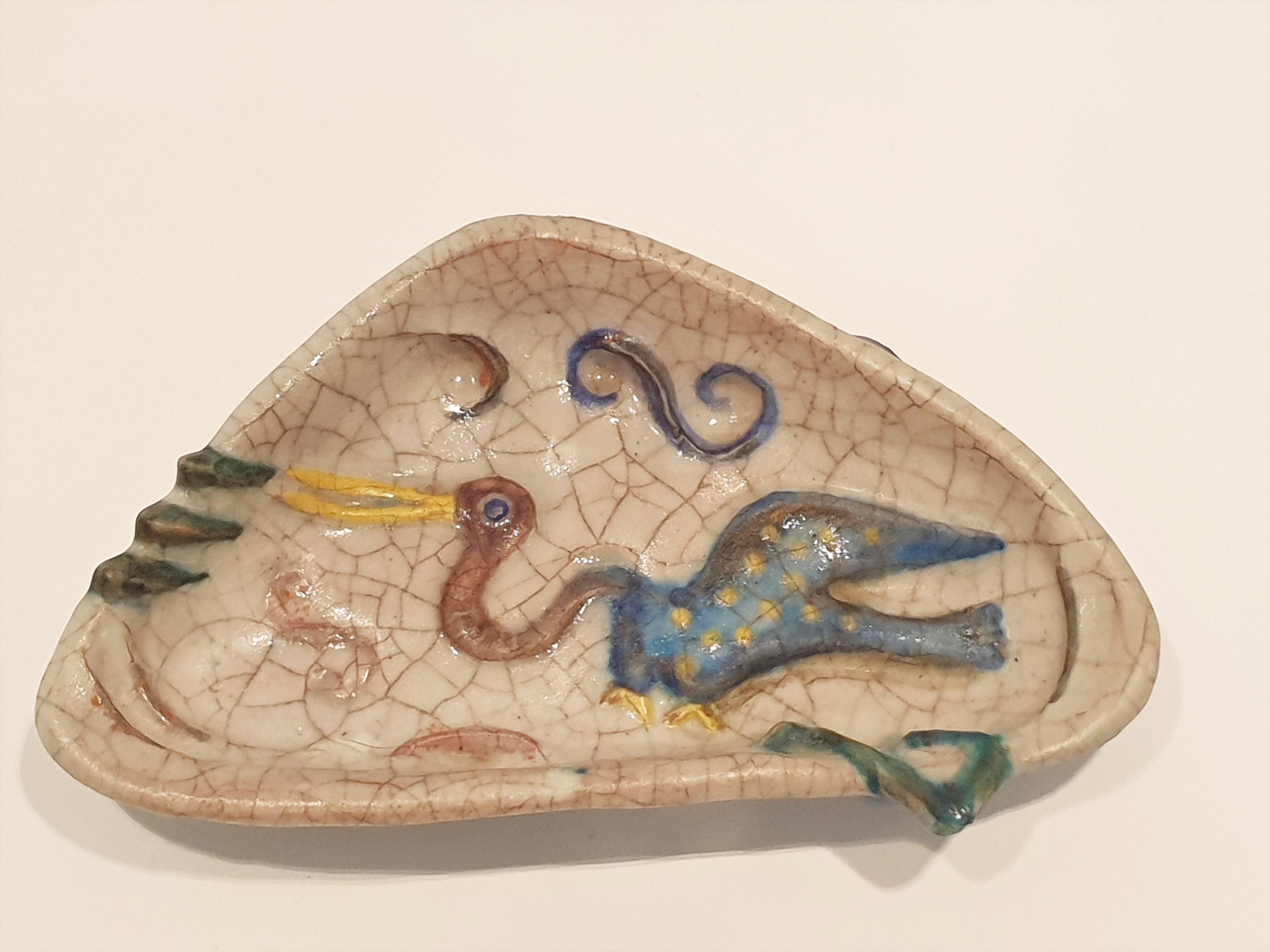 Colourful Mid Century, Italian ceramic dish with raised decoration of a stork in crackle glaze. Signed to the base Fantoni.
We have three dishes available.