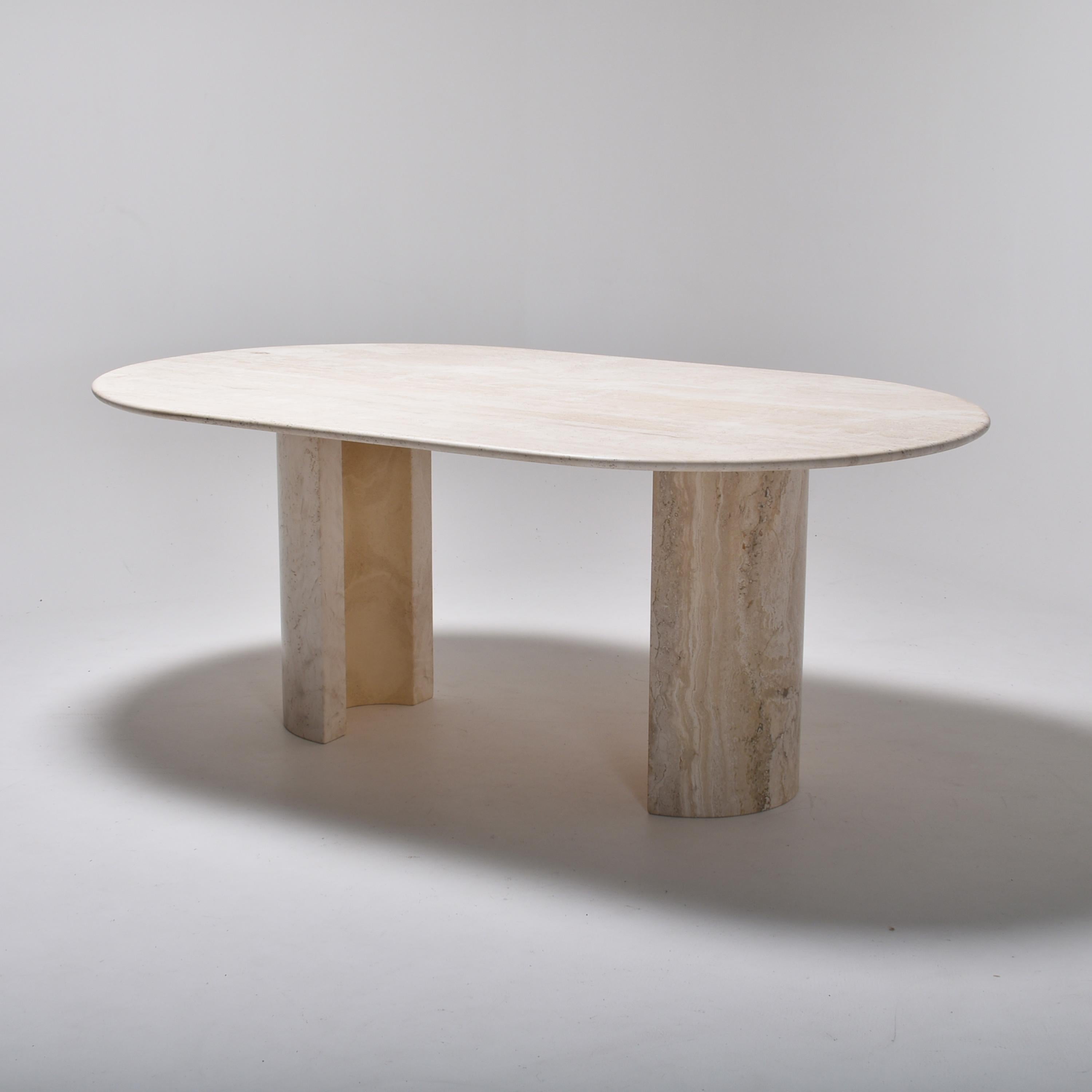 Midcentury dining table in cream travertine, made in Italy.
The oval tabletop lies on two half circles legs. The tabletop and the legs are of solid travertine, in a nice cream tone.
This post modernist work is typical of the Italian