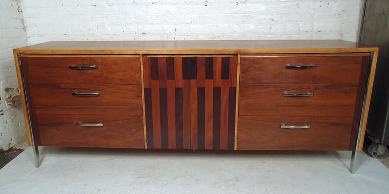 Large vintage modern credenza by Lane features nine drawers, metal pulls, sturdy metal legs, with a uniquely designed front.

Please confirm item location (NY or NJ).
