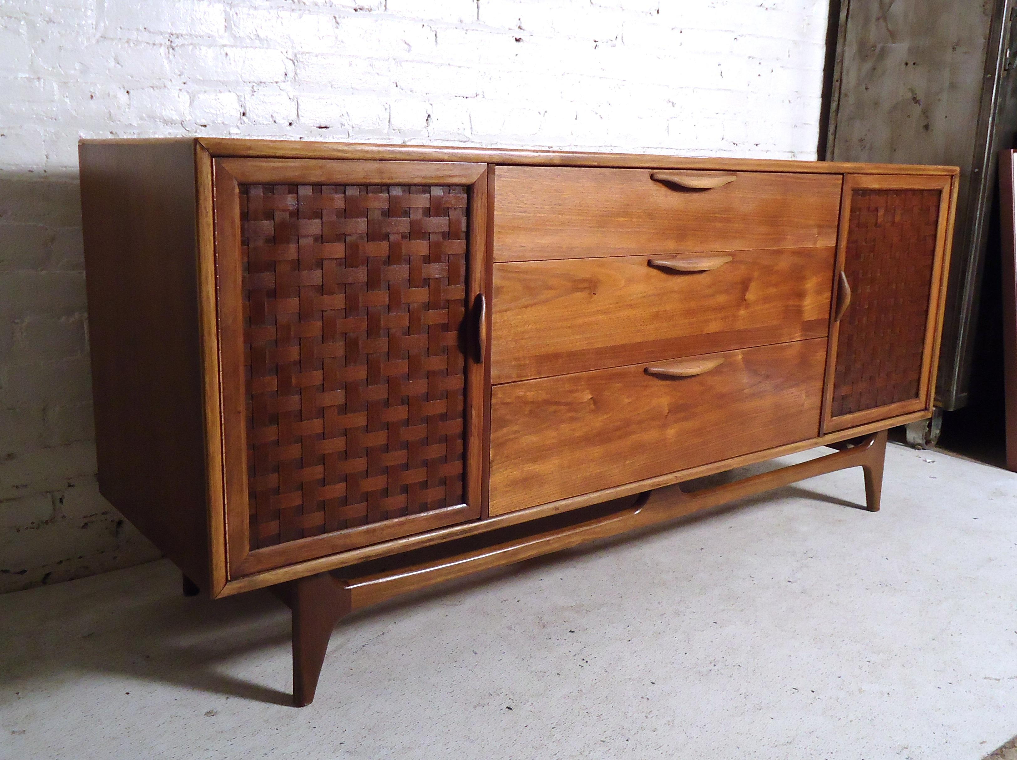 Gorgeous vintage modern credenza by Lane featuring basket woven doors covering a set of drawers on each side, nine drawers total. 
Please confirm item location (NY or NJ).