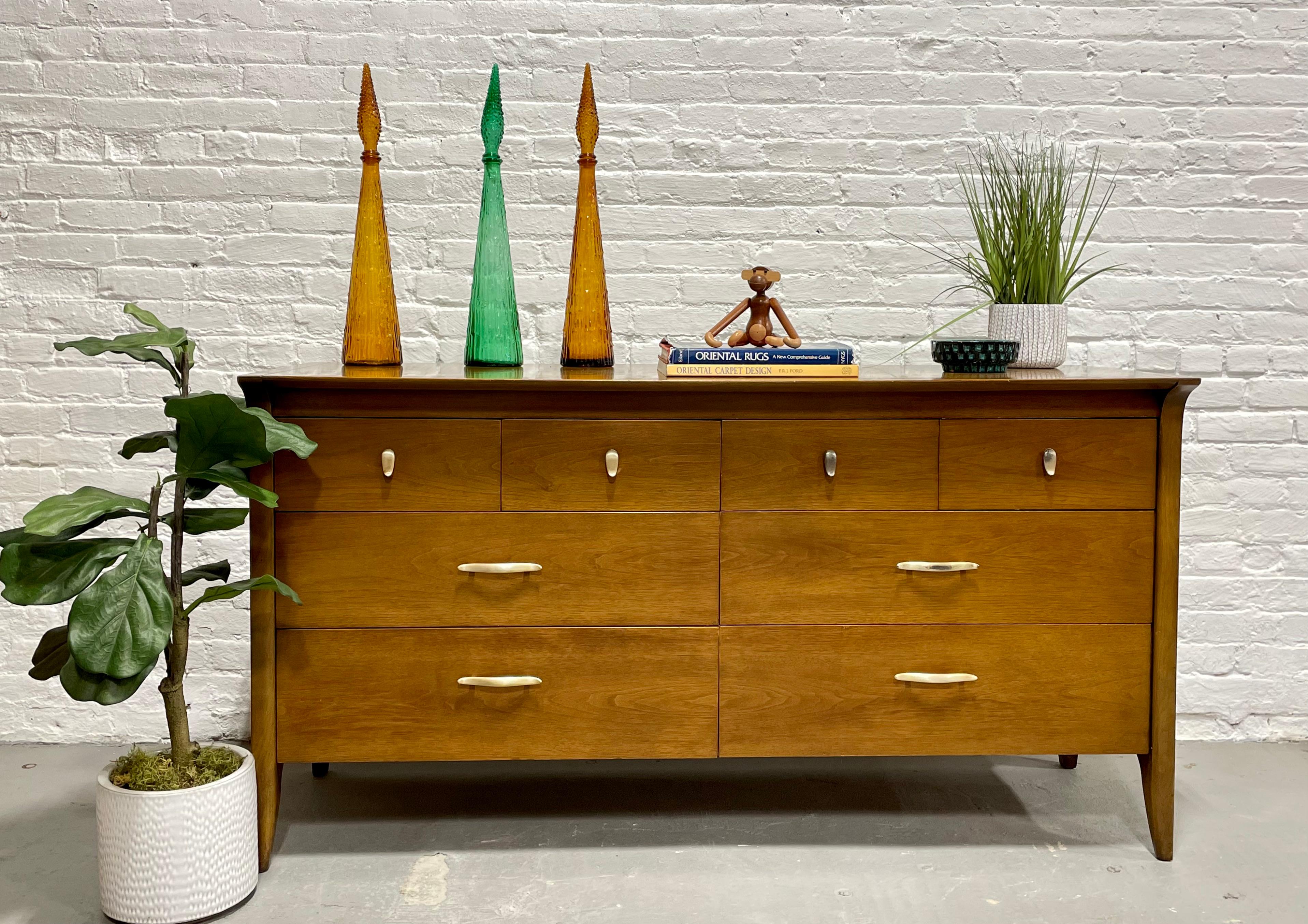 Mid-century Modern credenza / dresser by John Van Koert for Drexel Profile, circa 1957. The Profile collection is highly sought after and this credenza packs a punch with eight drawers in total. The top four drawers are smaller and perfect for