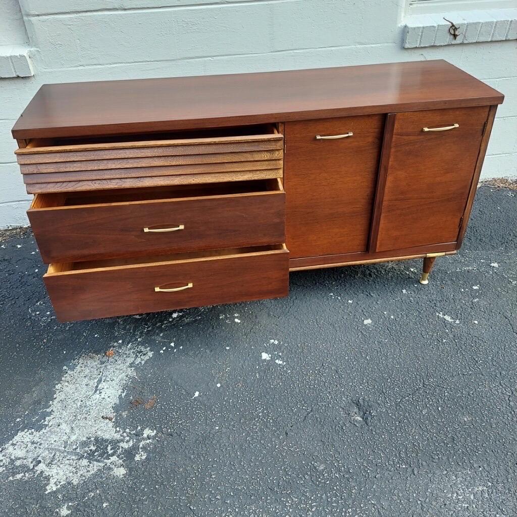 Vintage Mid-Century Modern credenza. Gorgeous wood construction with slatted details on the drawer. Constructed of solid wood and walnut veneer. Excellent storage! Can also be used as a console table, sideboard, dresser, buffet or entertainment TV