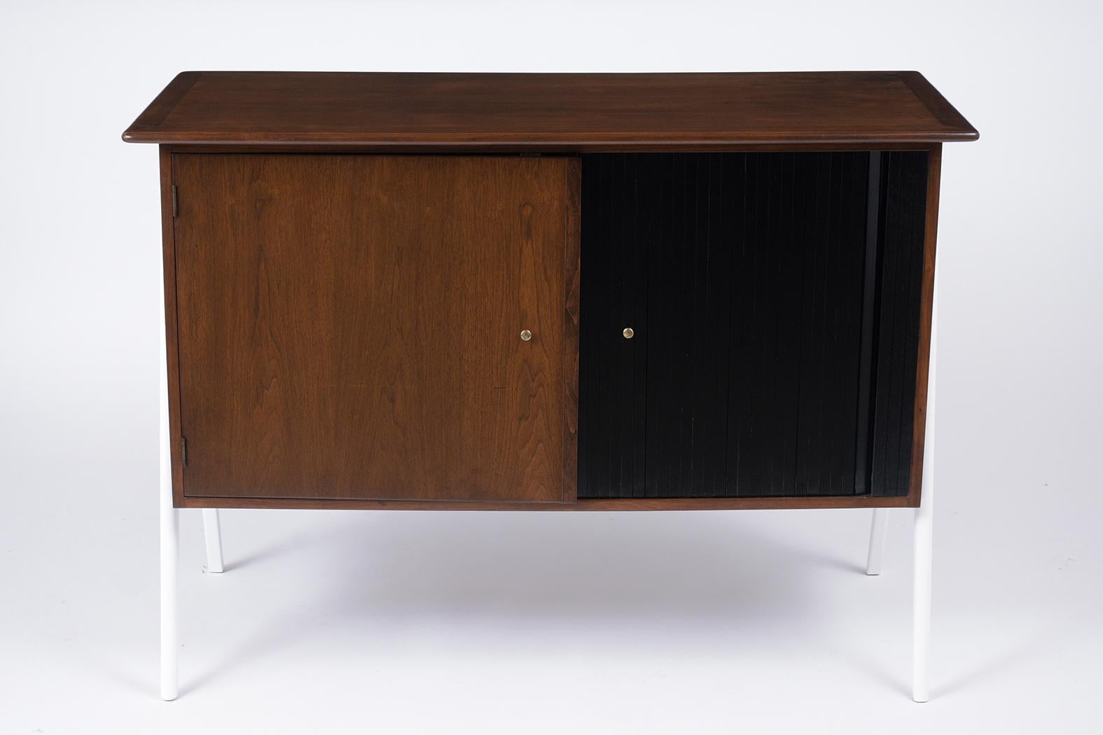This Danish 1960s two-sided walnut server is unique, has been restored, and has been stained in a walnut, white, black color combination with a newly lacquered finish. The front of the server features a single door with a brass knob and a single