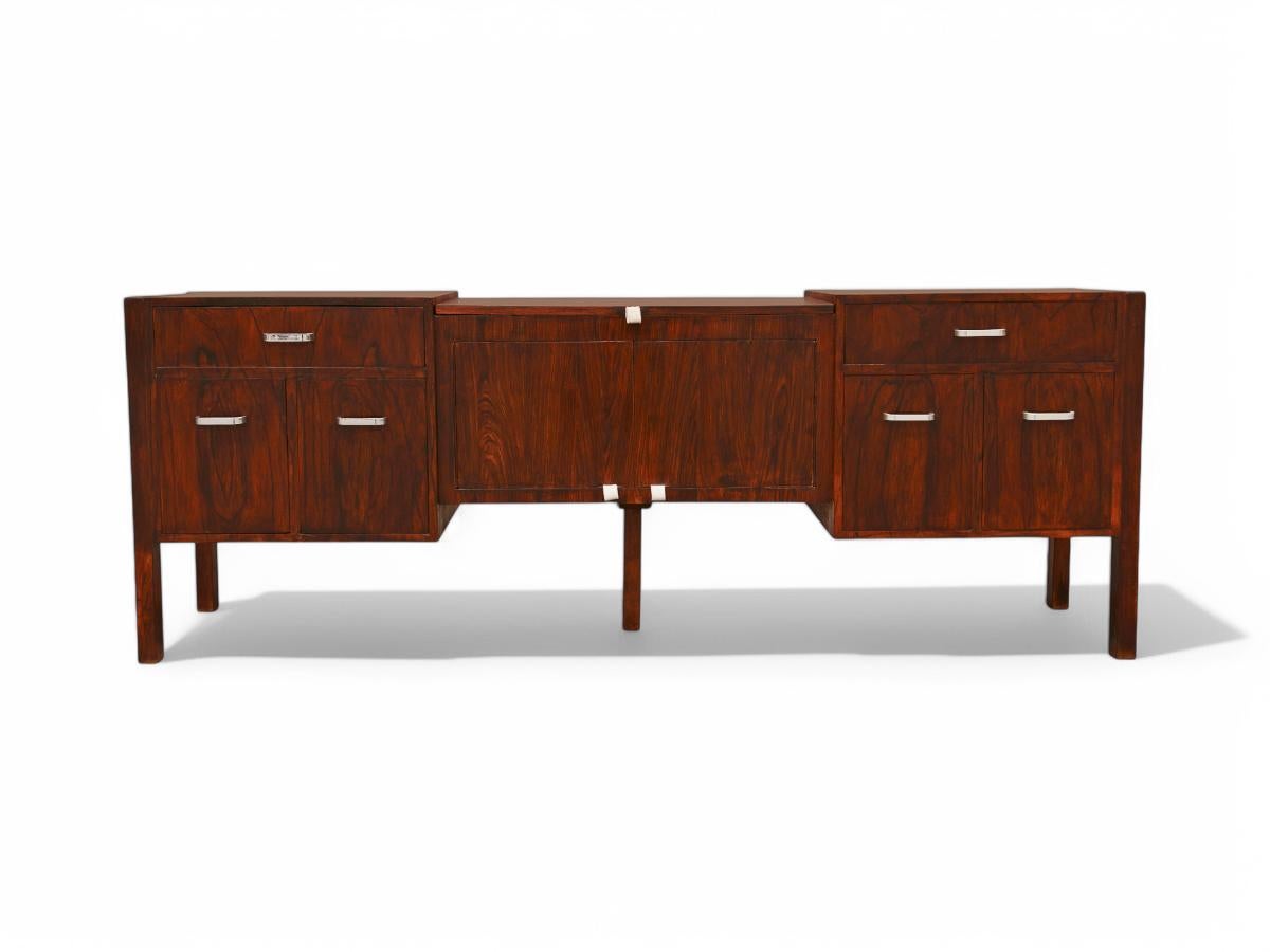 Available today, with domestic shipping in NYC metro area included, this Mid Century Modern Credenza in Brazilian Hardwood by Jorge Zalszupin, 1960s is nothing less than gorgeous!  

This credenza is crafted from Brazilian hardwood , featuring seven