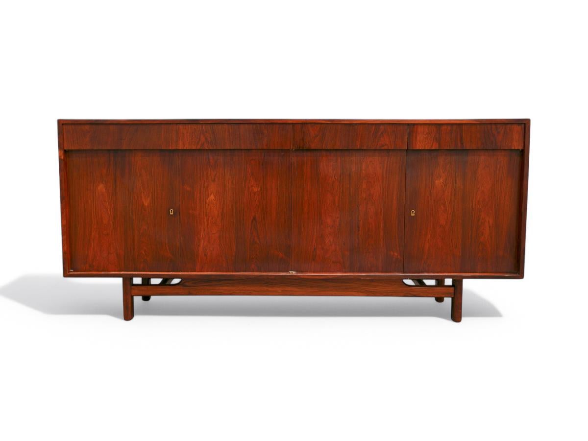 Available today, with domestic shipping in NYC metro area included, this Mid Century Modern Credenza in Hardwood by Sergio Rodrigues, 1960’s is nothing less than gorgeous!  

This credenza is crafted from Brazilian rosewood, also known as Jacaranda,