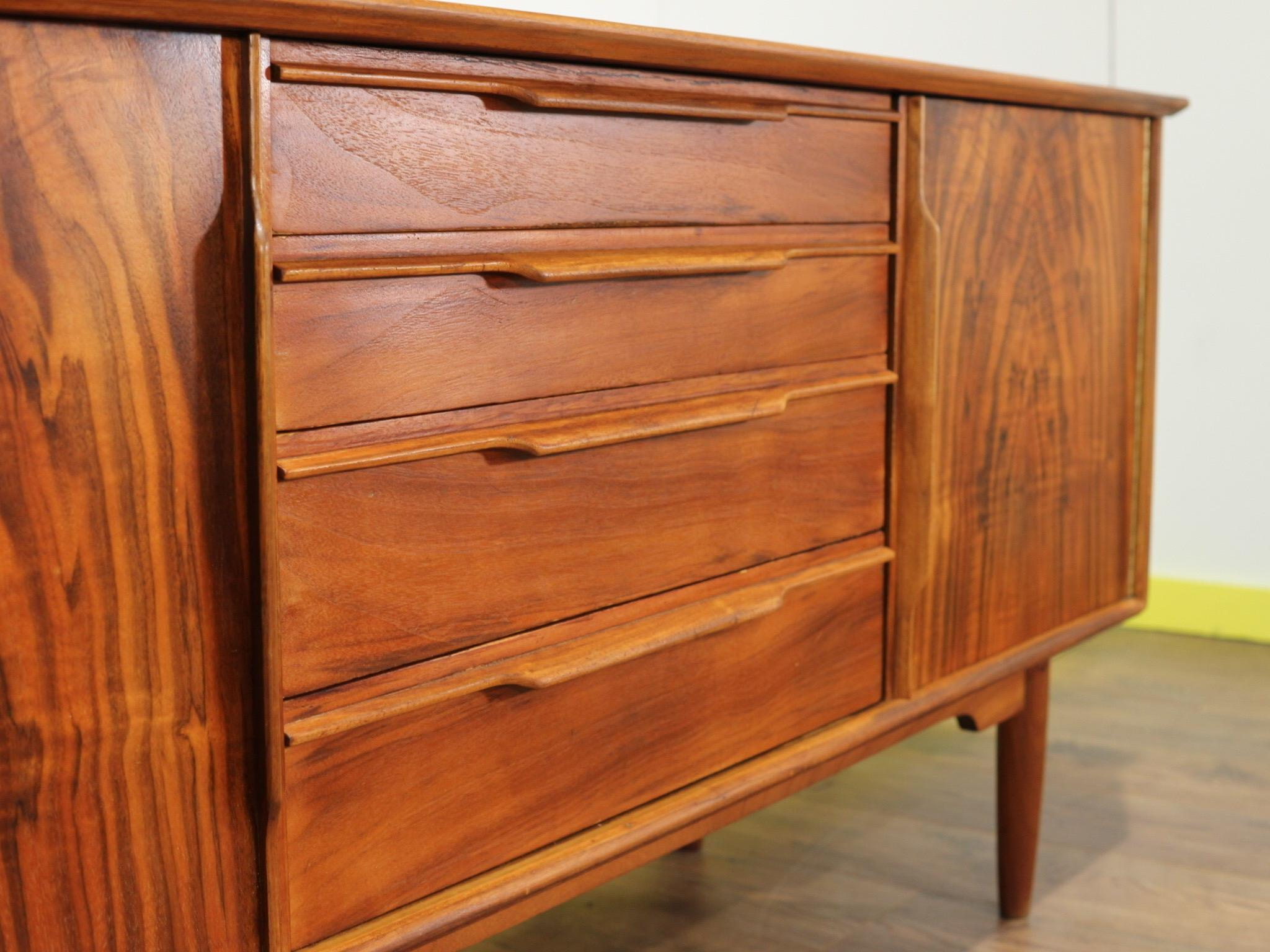 This truly stunning short credenza made by Scotish company, Morris of Glasgow is a real show stopper. The Grain of the wood really does make it stand out from the crowd. With plenty of storage while being compact it would looke great in any home.