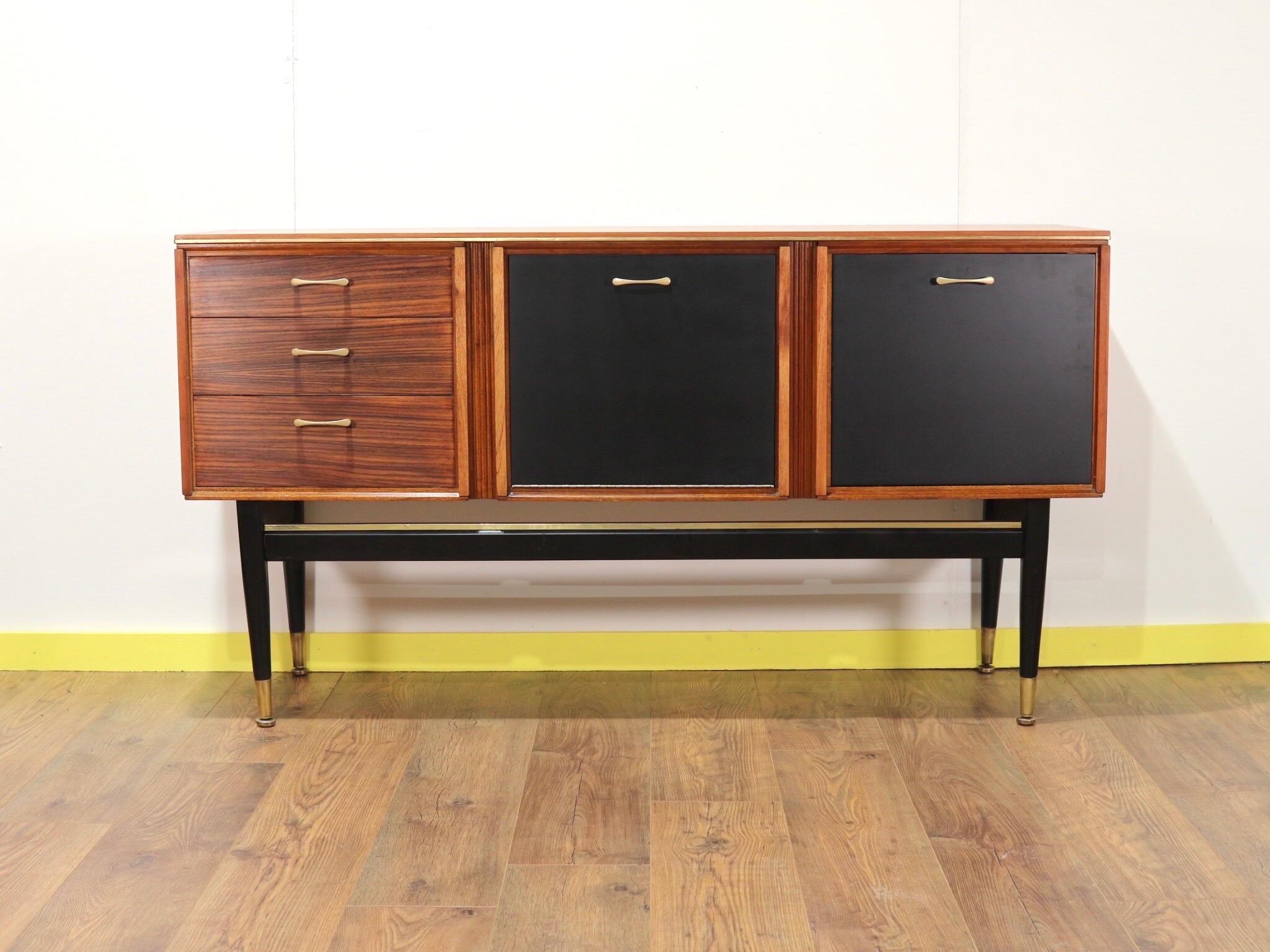 A beutifully designed credenza by british cabinet maker Stonehill Furniture.

Stood high on black tapered legs this cabinet would have been originally used as a cocktail cabinet but with plenty of storage could have plety of uses.

A real