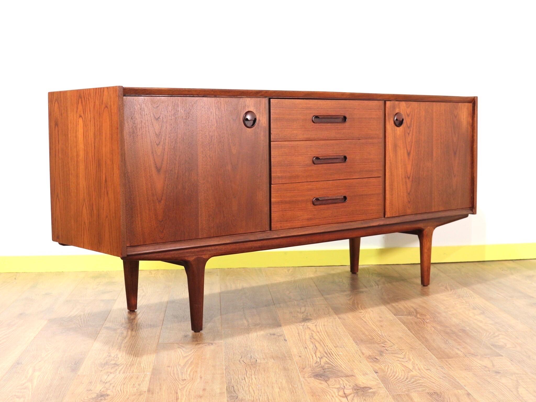 A gorgeous credenza made by British cabinet maker, Wrighton. This piece furniture has a beautiful grain and deep colour in the wood and a stunning look, especially the frog eyed handles.

A real head turner for any space.