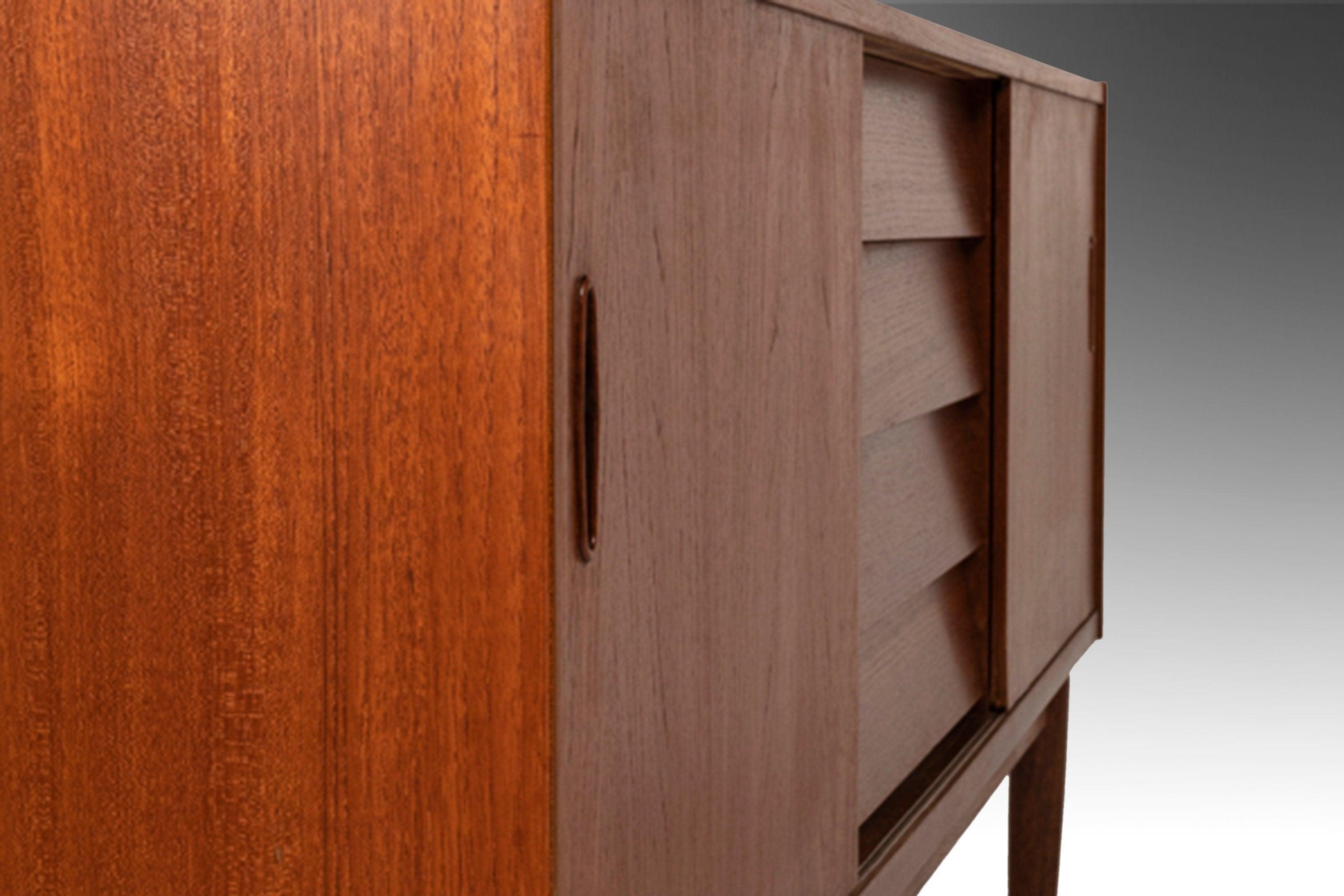 As functional as it is visually striking this gorgeous credenza, designed by the renowned Nils Jonsson for Hugo Troeds, is an exceptional example of Scandinavian Minimalist design. Constructed of teak with exceptional woodgrains this sideboard