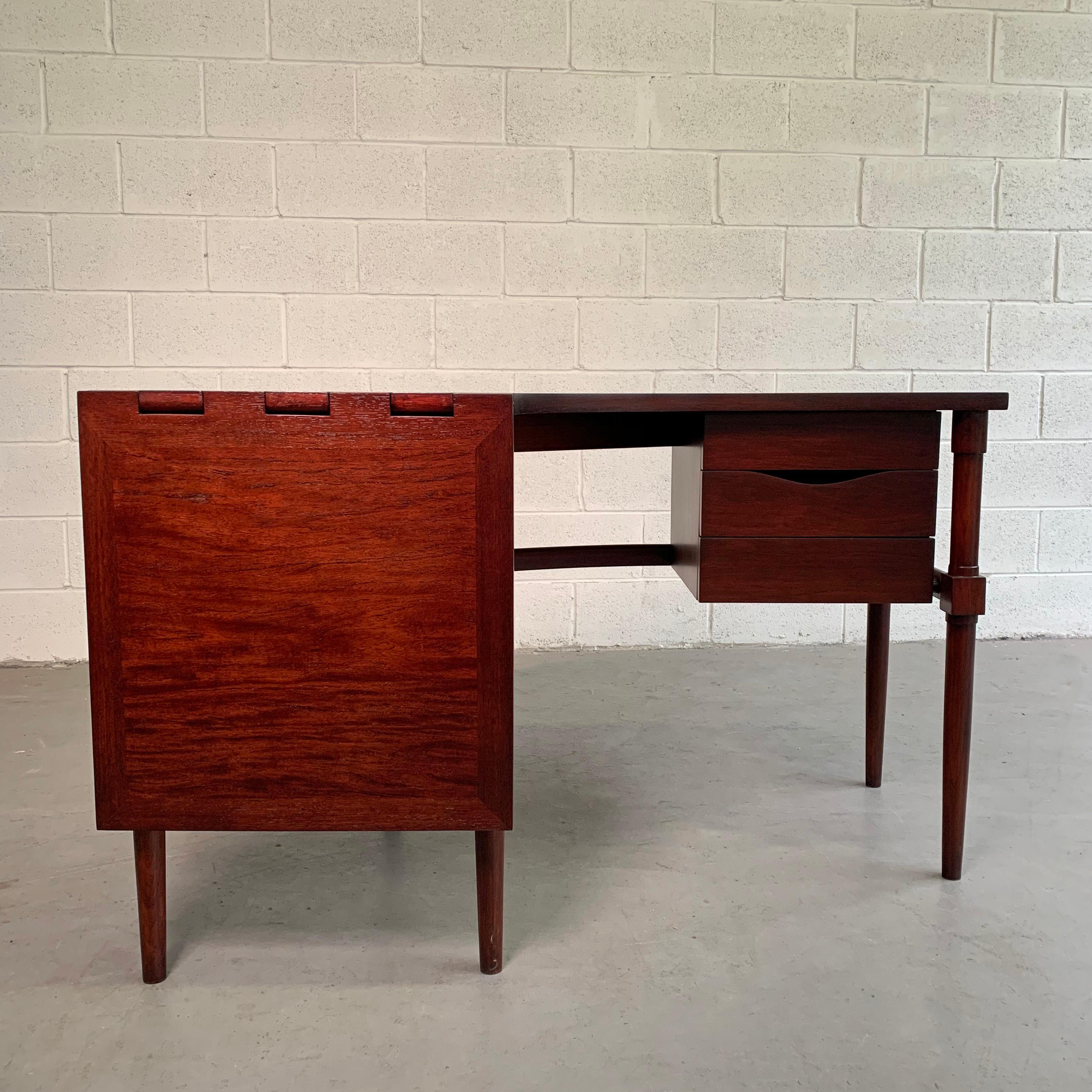 Mid-Century Modern, crescent-shaped, walnut desk features wonderful details throughout with 3 drawers and a 20 x 20 inch drop leaf to extend for more surface. The overall surface width of the desk is 20 inches and is 54 inches deep when fully
