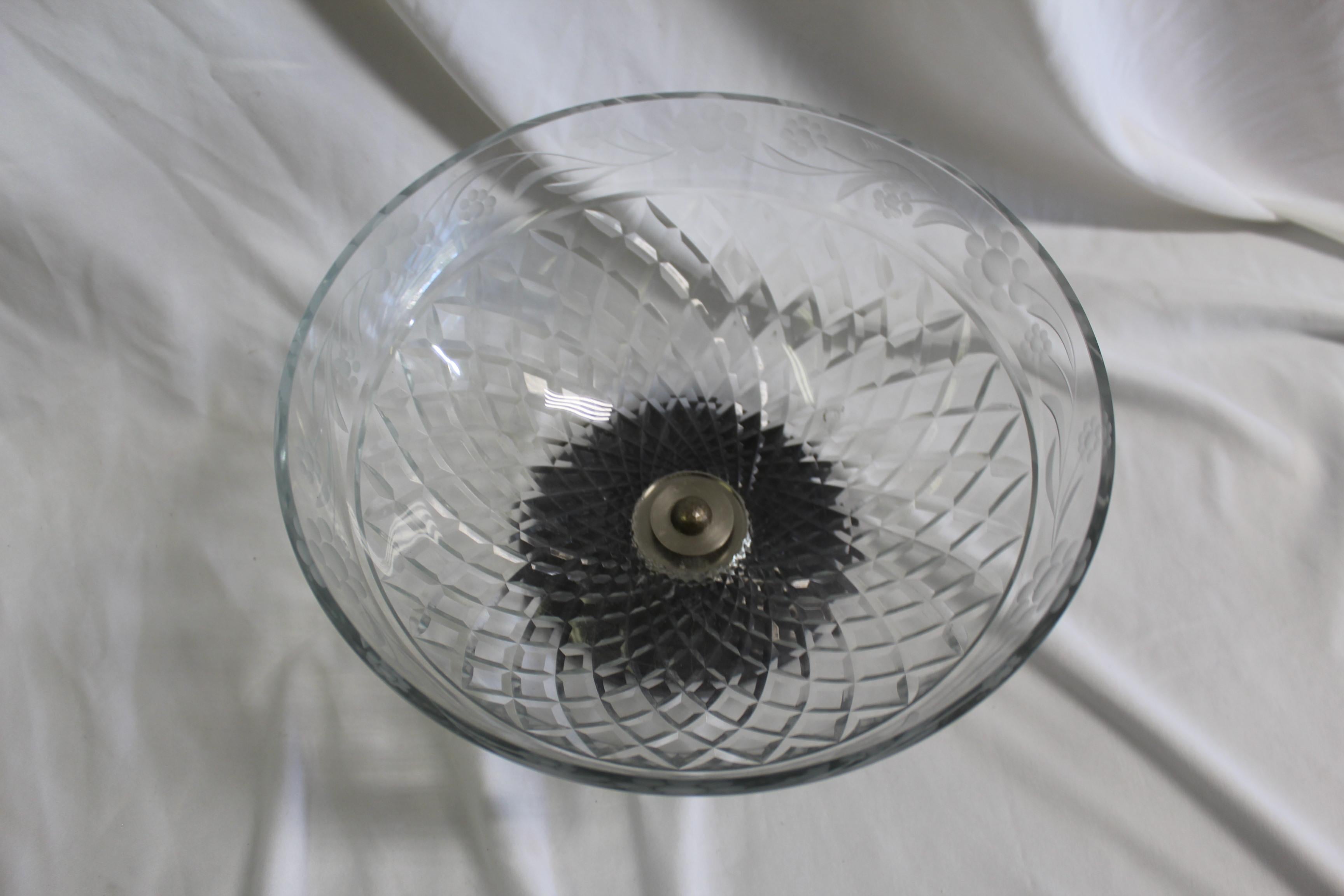 A wheel cut lead crystal bowl from Checz cut in the Diamond pattern and Flowers on the upper rim. Custom designed with an Absolute Black Marble base. Cut in a cone shape and hi-polished.
 