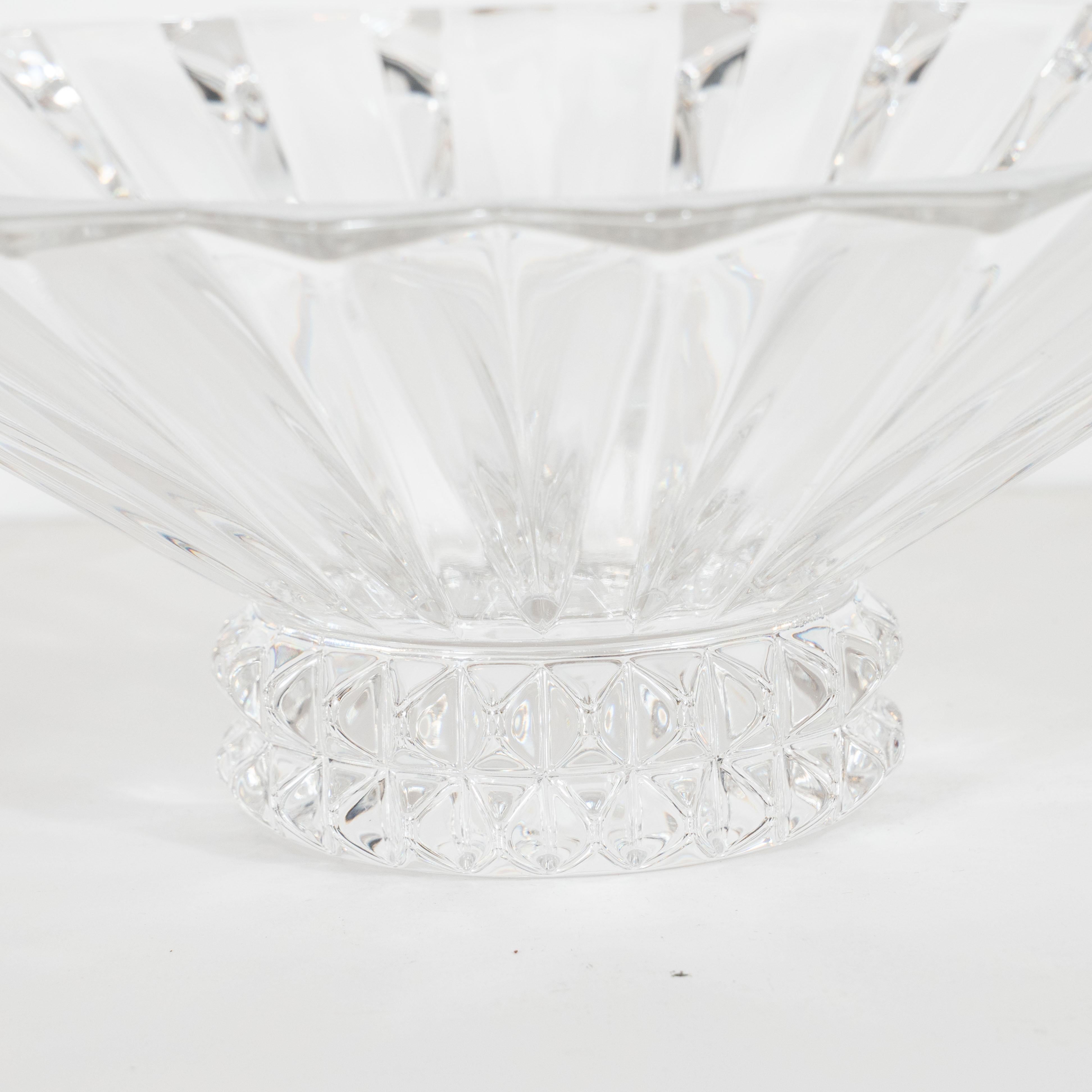 This elegant centerpiece bowl was realized by the illustrious 20th century design firm, Rosenthal, in Germany circa 1980. It features a circular form with a sunburst pattern in relief adorning its neck and a scalloped mouth offering an abundance of