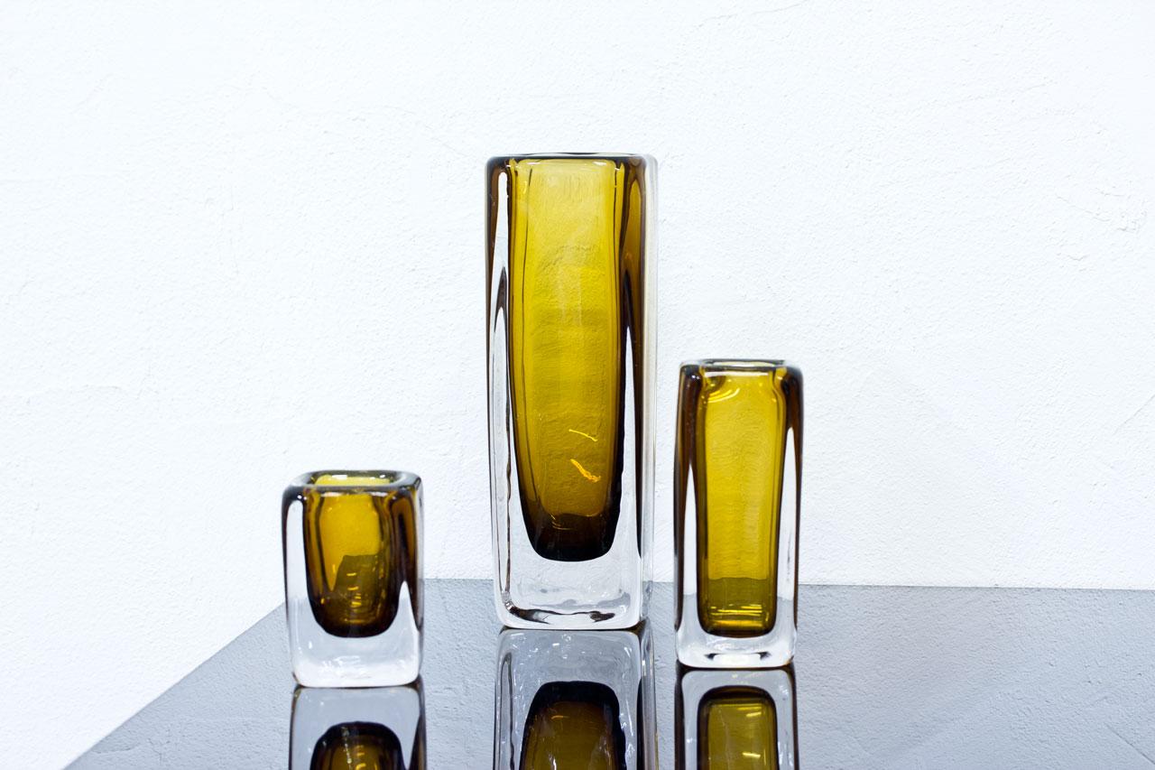 Set of 3 crystal glass vases by Vicke Lindstrand for Kosta. Made in Sweden during the 1950s. Amber colored glass cased in clear. Tall and small ones signed Kosta.
Dimensions: H 11/ 16/ 26.5 x W 6.5/ 7/ 9 x D 6.5/ 7/ 9cm.