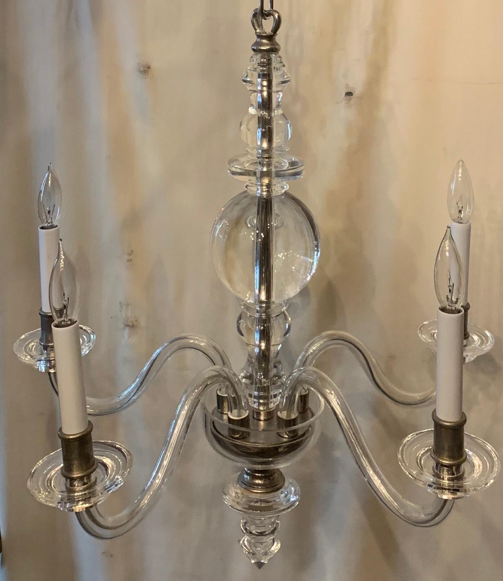 A Mid-Century Modern stream line clear crystal and polished nickel 5 candelabra light fixture petite fine quality, heavy chandelier in the manner of Baccarat.