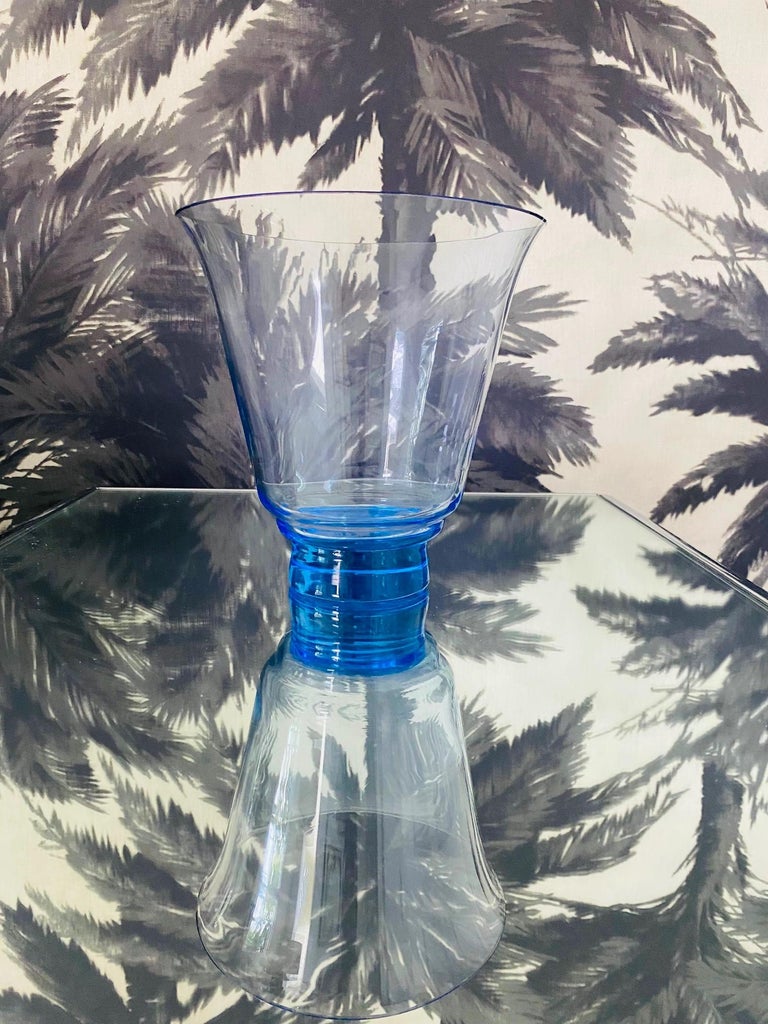 Vintage Czech Republic handblown crystal vase in translucent electric blue. The vase has a tapered form with a raised base. Colored blue glass will change hues according to the surrounding light and at times has lilac undertones. Makes a chic