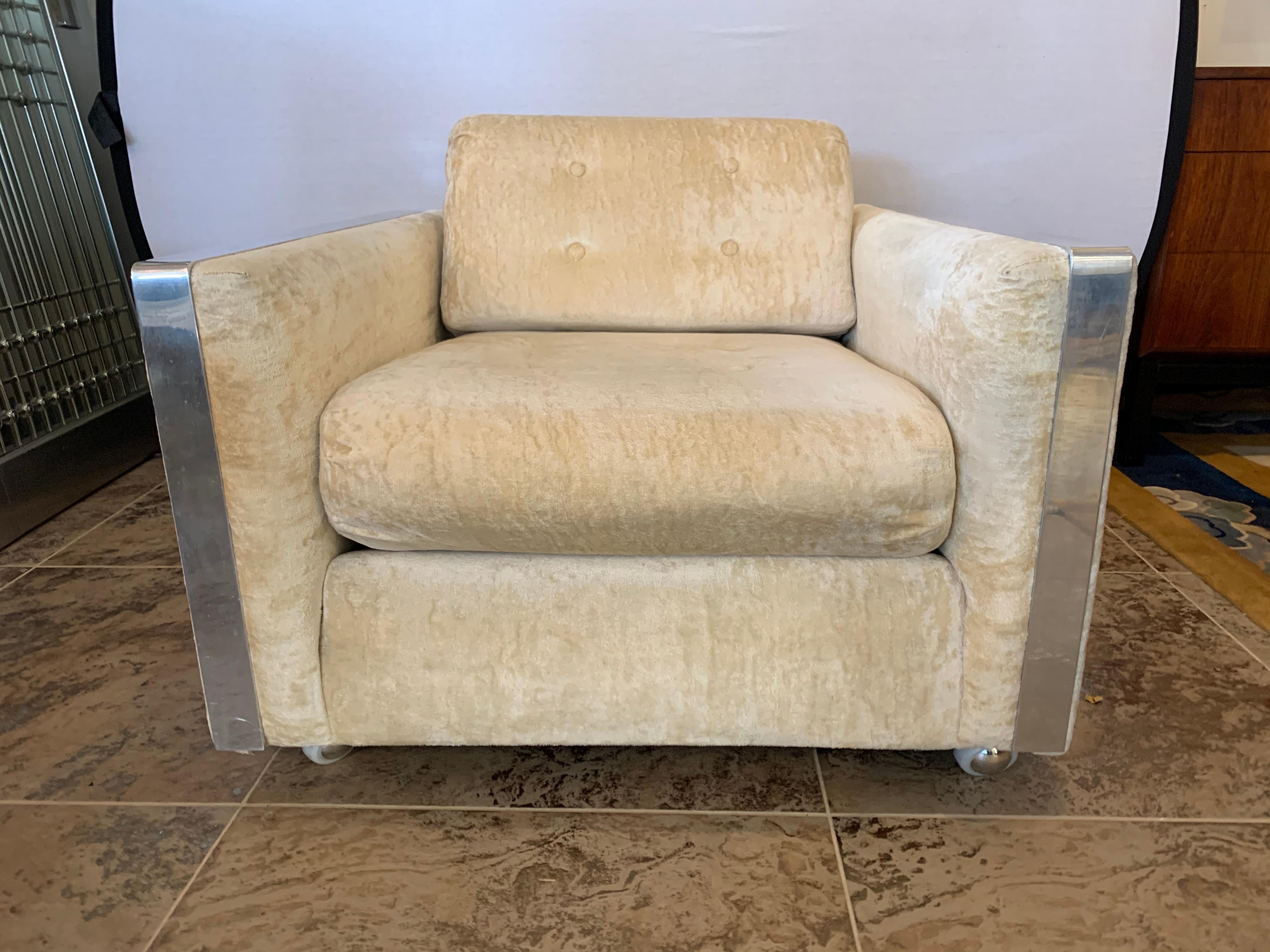 True period lounge chair in the manner of Milo Baughman which features front caster wheels for ease of movement, velvet fabric and chrome at borders. The very definition of sleek. Now, more than ever, home is where the heart is.