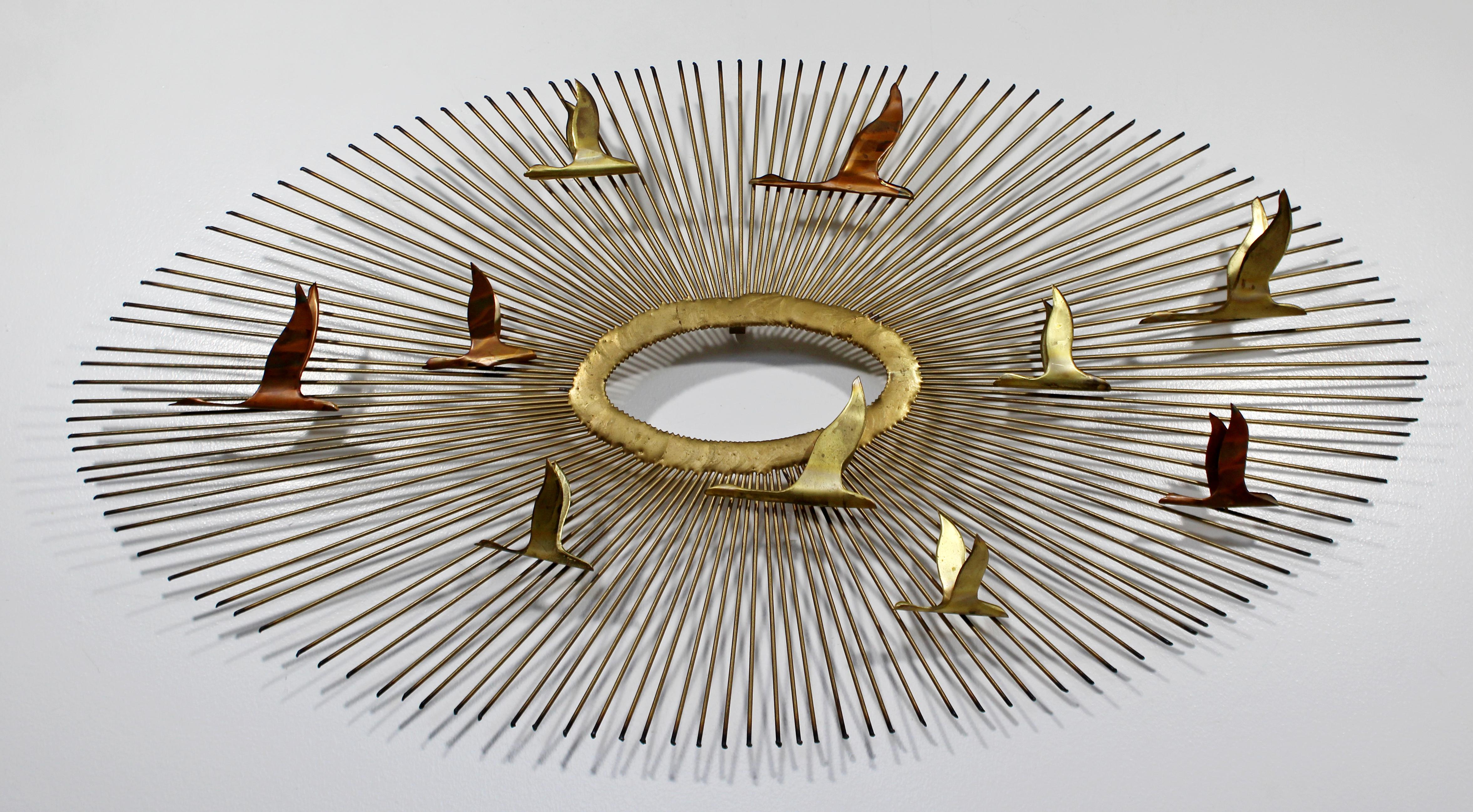 For your consideration is a stunning, sunburst with birds in flight, brass, hanging wall sculpture, attributed to Curtis Jere, circa 1960s. In excellent condition. The dimensions are 38