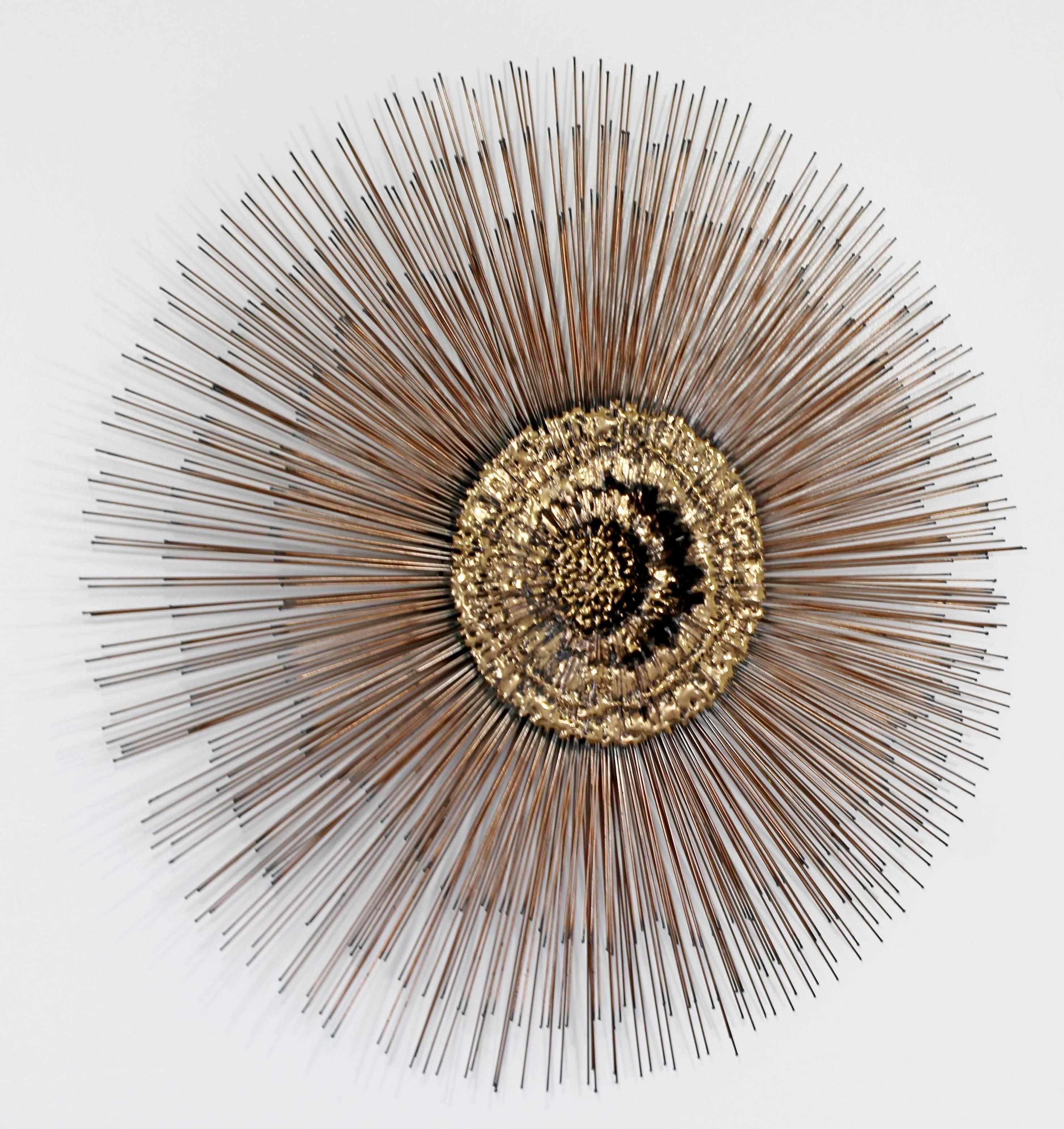 For your consideration is a beautiful, brass, hanging wall sculpture in the form of a starburst, by Curtis Jere, circa 1970s. In excellent condition. The dimensions are 29