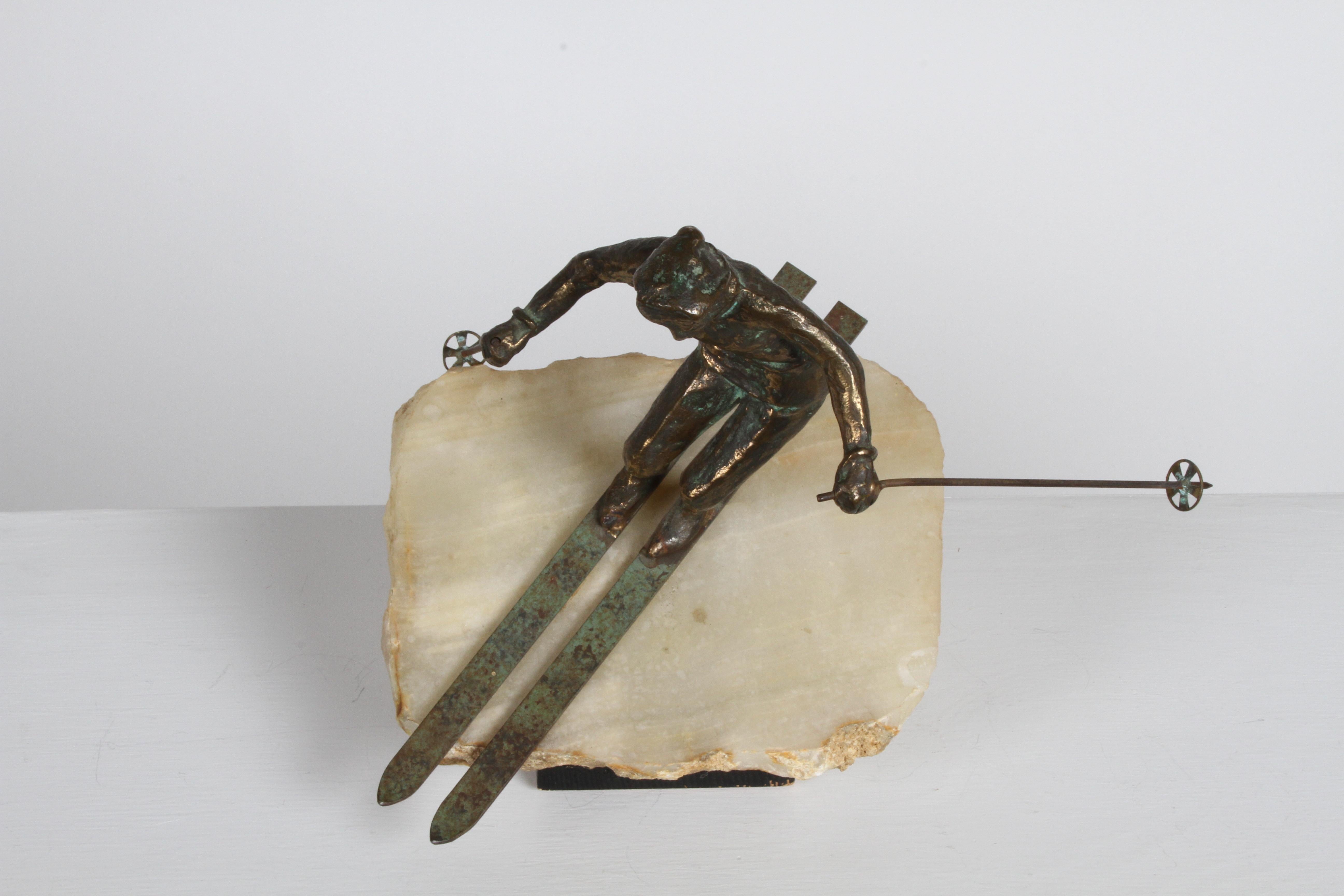 A very cool bronze downhill skier sculpture on a solid block of onyx by C. Jere, circa 1960s. The piece is signed 