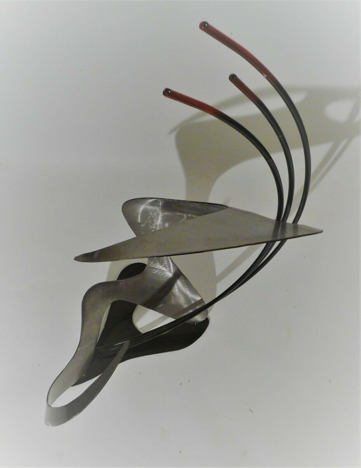 This is an original curtis jere Mid-Century Modern tabletop abstract metal sculpture. Signed on bottom. Features sweeping metal plate and rods in an upsweep design. Biomorphic metal base. Sophisticated abstract colorful design that changes every