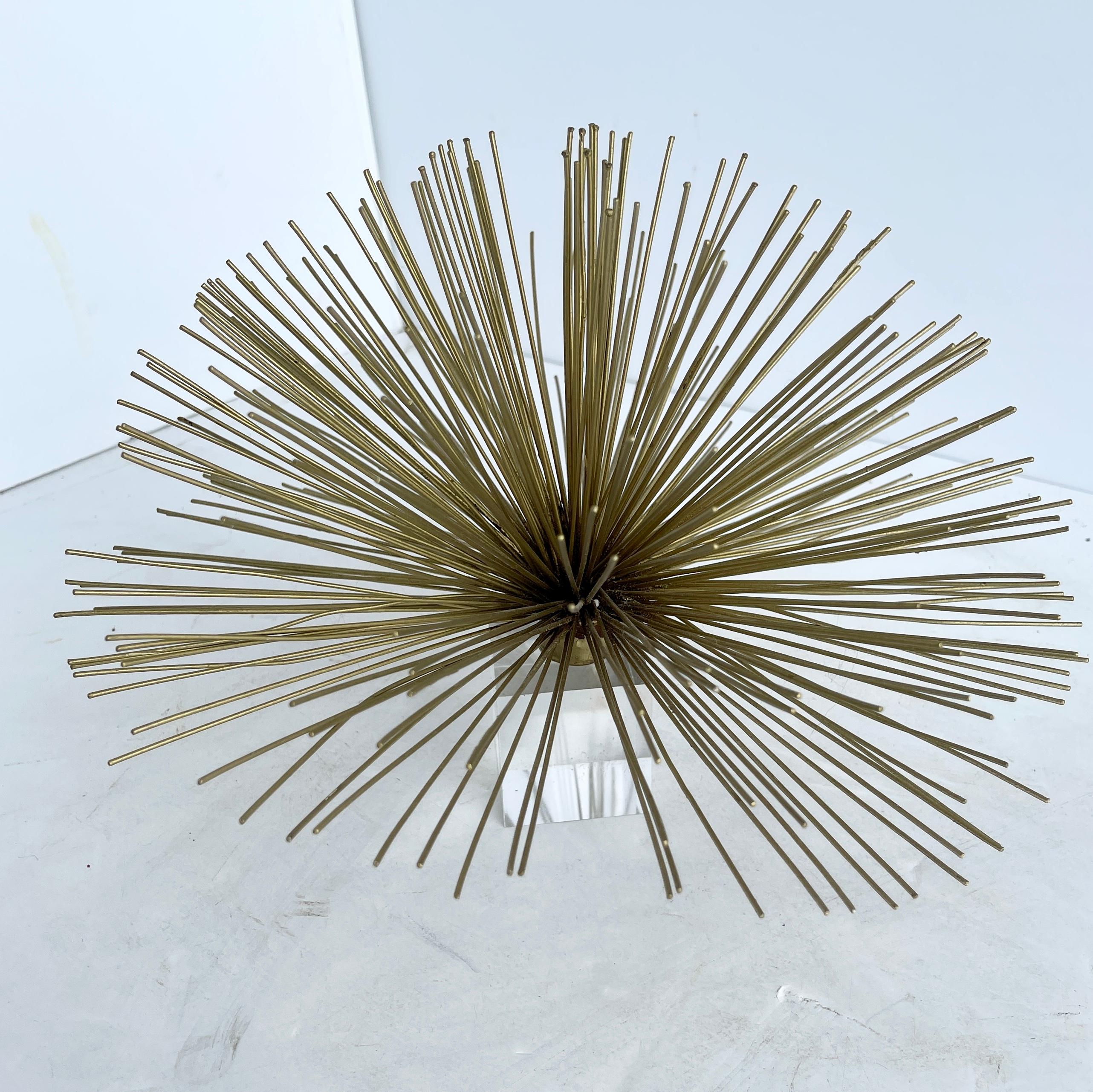 Mid-Century Modern pom-pom wall sculpture, in Curtis Jere style.
This Brutalist brass wall sculpture is an iconic Pom-Pom or Starburst design in the manner of Curtis Jere. The sculpture captures the 1960s-1970s with its architectural form and
