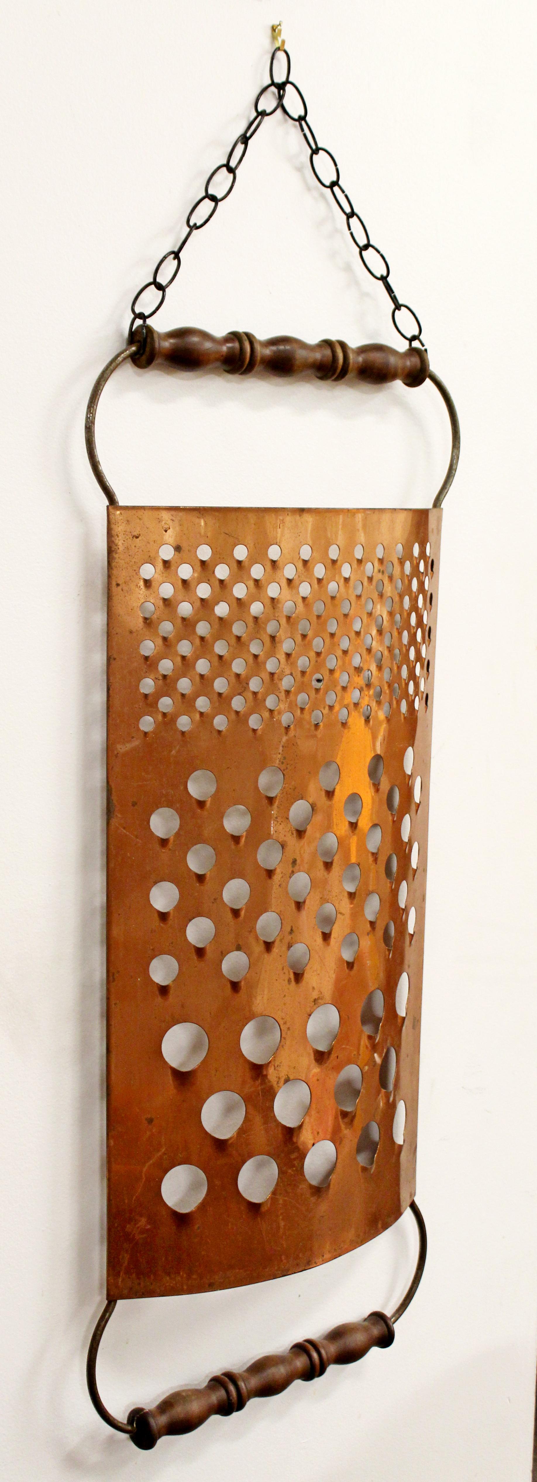 For your consideration is a creative, copper wall sculpture of a large cheese grater, signed by Curtis Jere, and dated 1979. In excellent vintage condition. The dimensions are 17