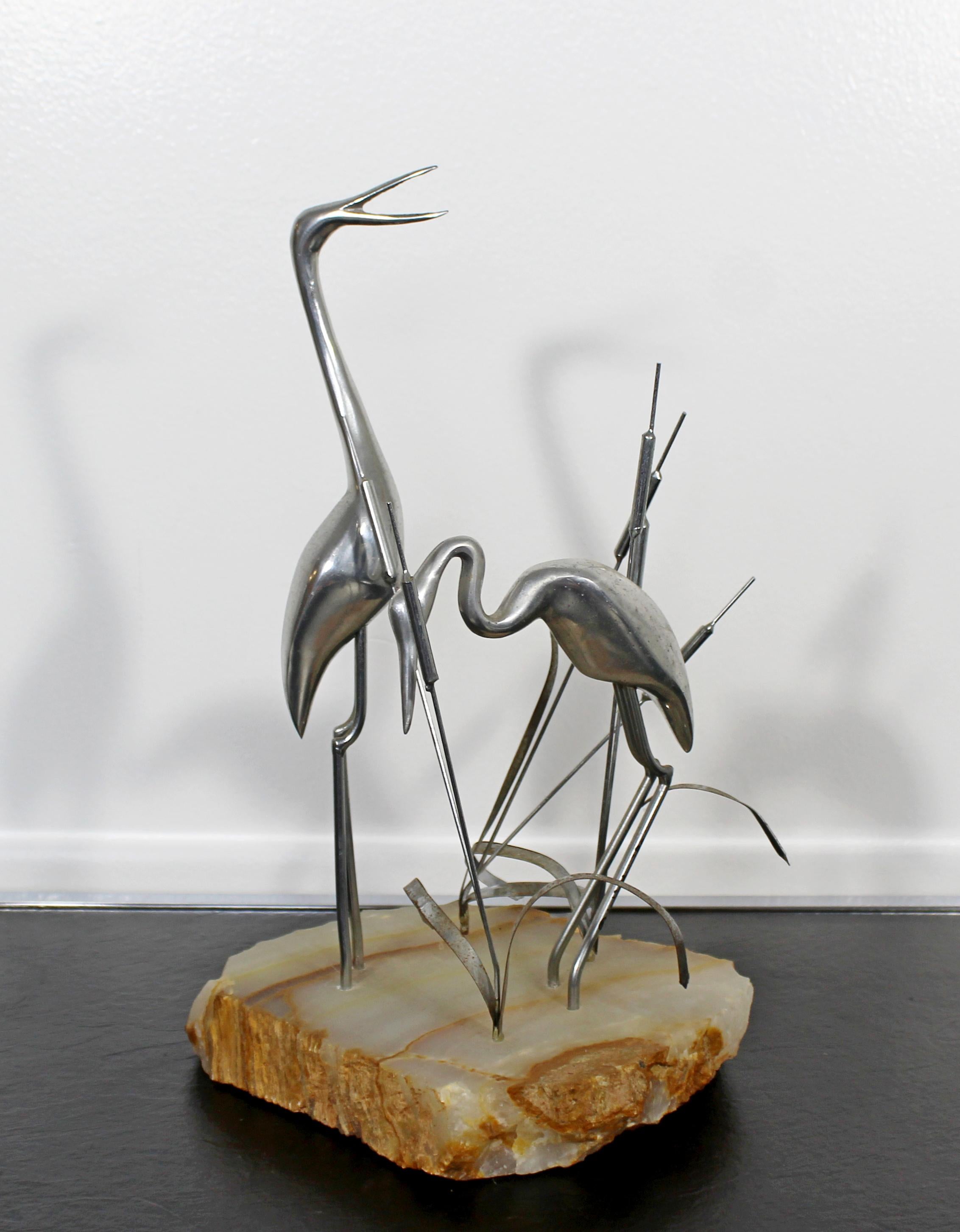 For your consideration is a lovely, metal table sculpture on a stone base, of herons and cattails, signed by Curtis Jere, circa the 1987. In excellent condition. The dimensions are 7.5 W x 7