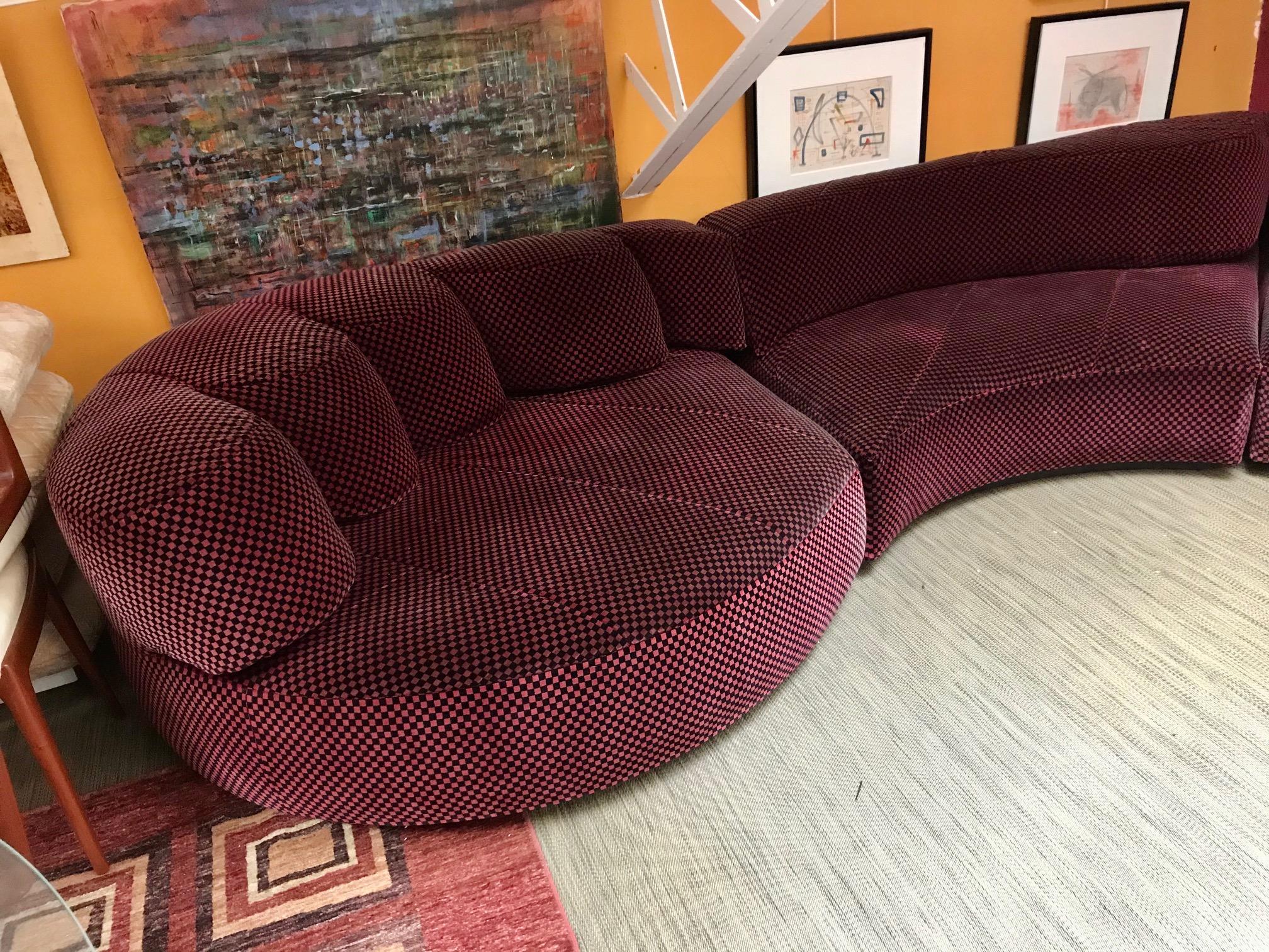 In the style of Andrée Putman
A large curvy sectional sofa produced in the 1970s.
Cloth red and black checkerboard.