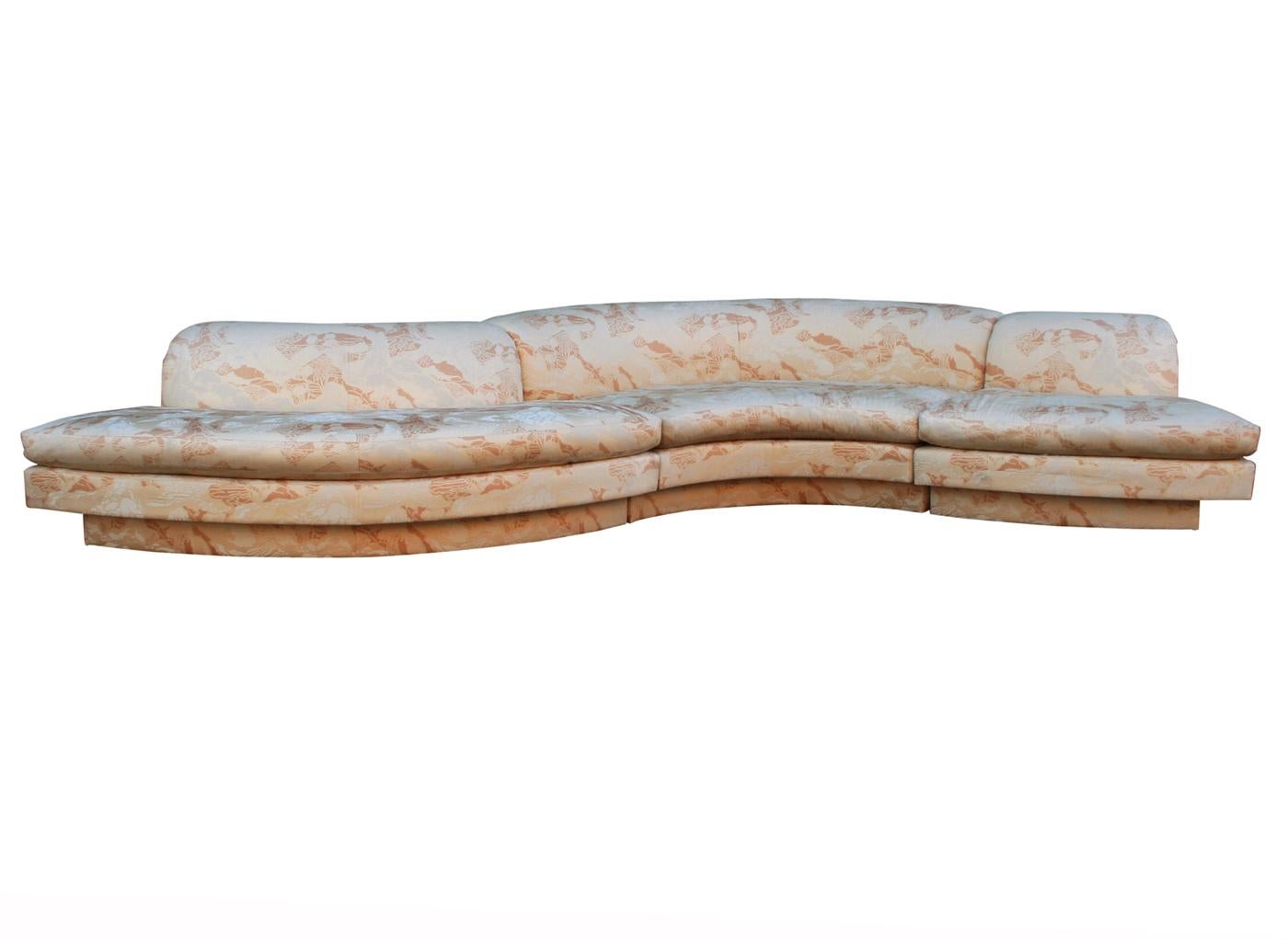 A large curved 3-piece sectional sofa from the early 1970s. This piece boasts clean design lines with a freeform shape. Fabric is original and clean, but could use updating. Foam and padding are excellent.