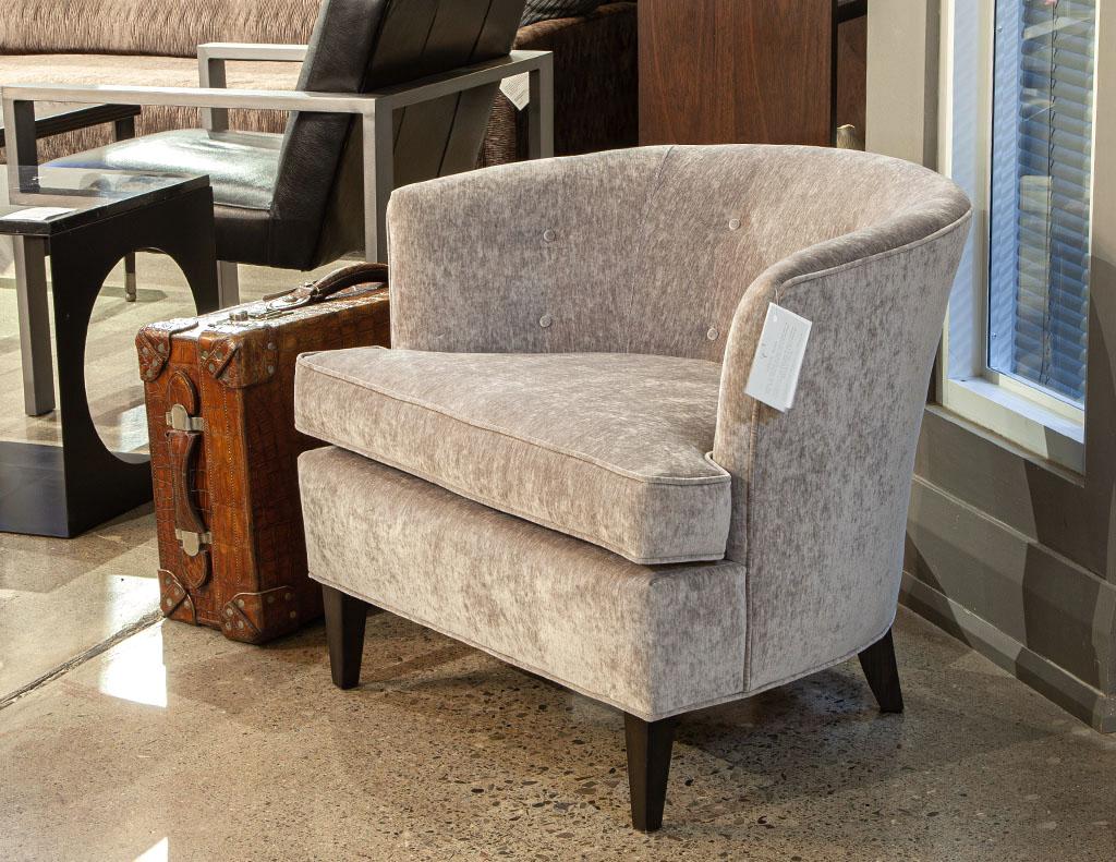Mid-Century Modern curved back lounge chair. Iconic 1960’s mid-century modern styling. Featuring unique curved back with tufted buttons. Completed in a grey velvet material with thick plush seat cushion. Walnut legs are finished in a satin dark