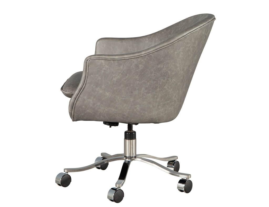 Mid-Century Modern curved leather office chair. America, circa 1970s. Original Mid-Century Modern design with sleek curved shaping. Masterfully restored in premium Italian leather in a charcoal grey color tone. Completed with a large stainless-steel