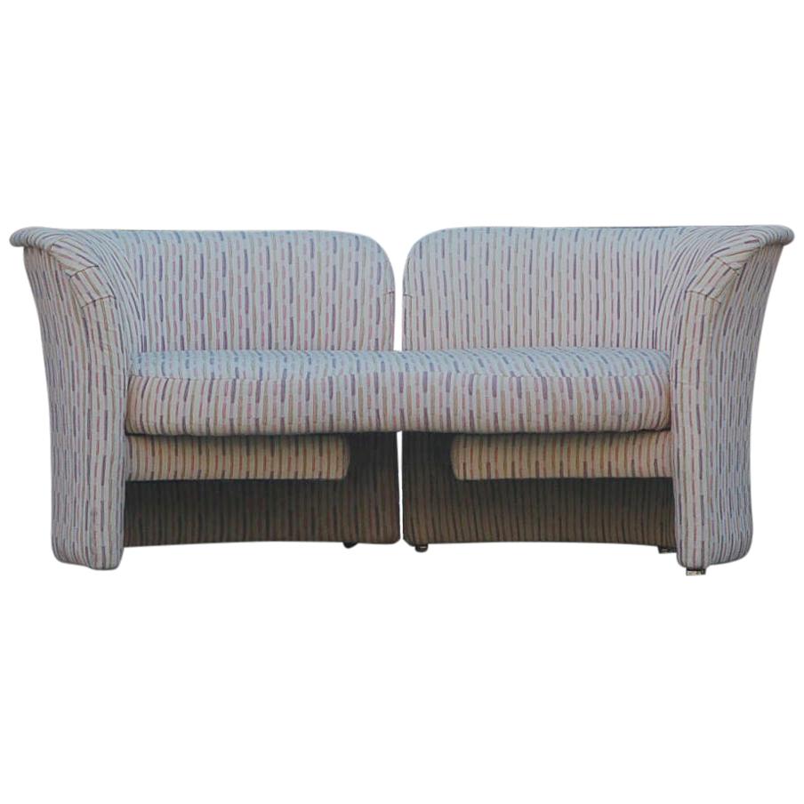 An innovative loveseat designed by Randy Culler and produced by Thayer Coggin in the 1970s. This sofa has a rotating arm on one side to make a chaise lounge or a tete a tete. Sofa retains its original fabric. Its clean but dated. Manufacturers label.