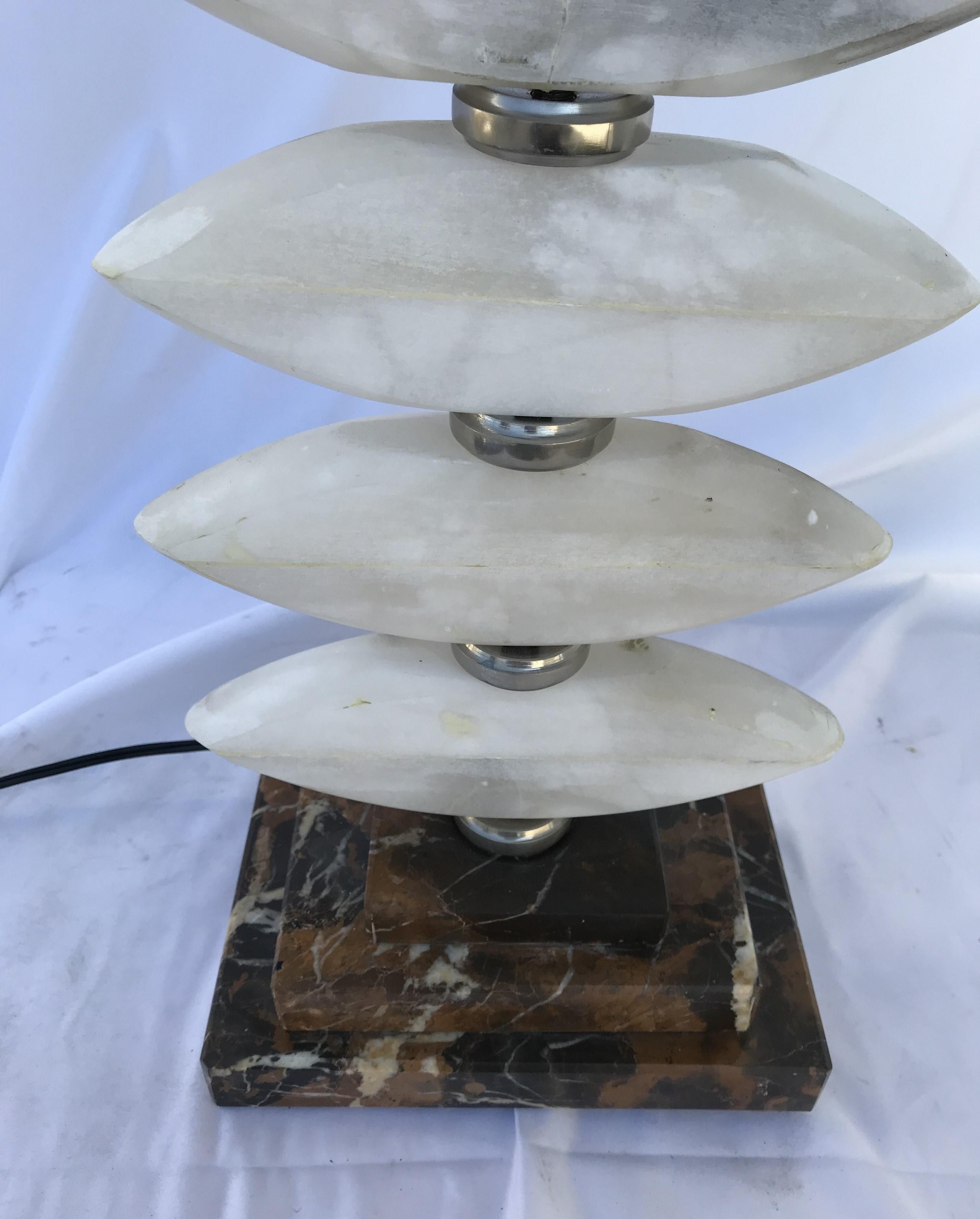 A Custom designed Alabaster Lamp with Art Deco style by a designer in Los Angeles .  Custom made for him and showroom . All Alabaster slices put together and separated by Hi-polished round spacers . Sitting atop a 6