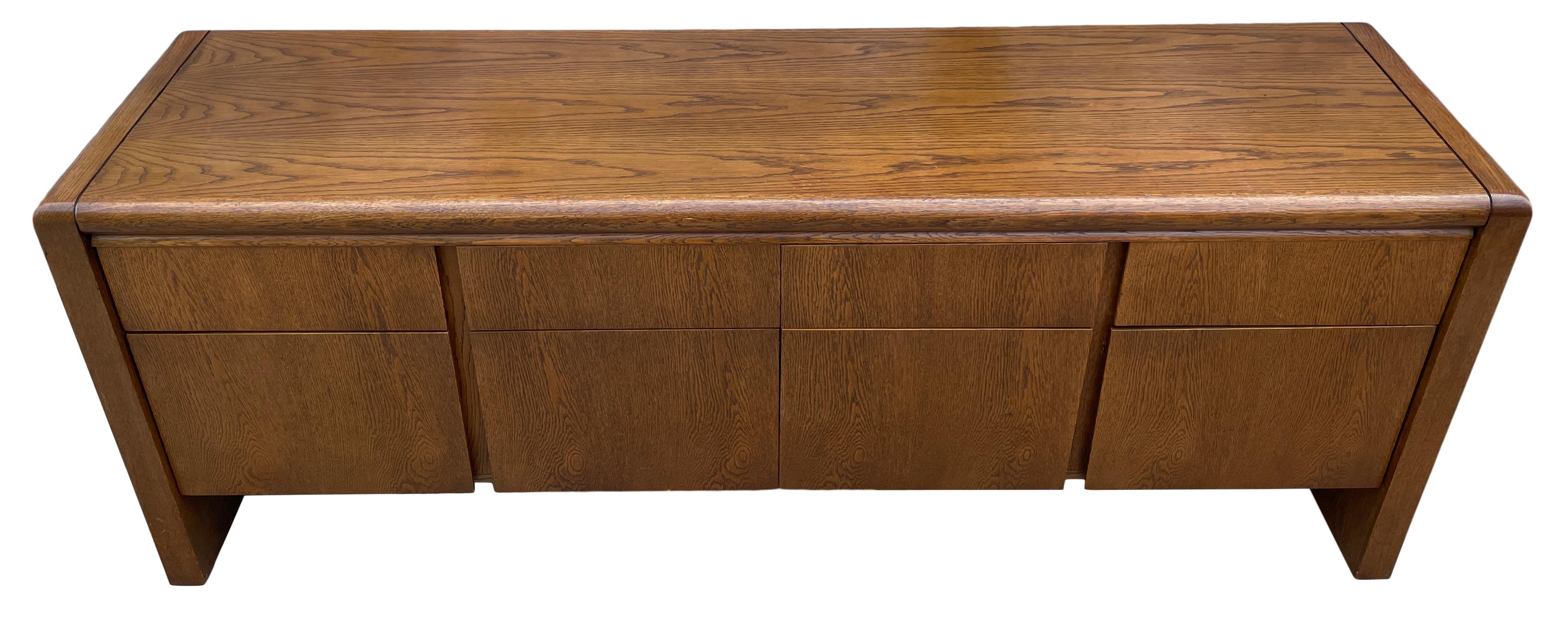 Mid-Century Modern 1980s American custom waterfall Oak credenza cabinet 8 drawer style of Florence Knoll or Milo Baughman. Beautiful design very solid credenza with 4 upper drawer and 4 lower deeper file drawers. All drawers have metal smooth