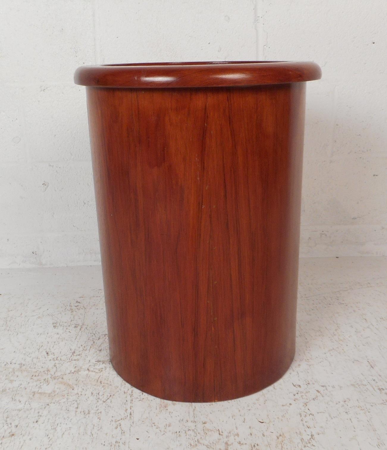 This beautiful vintage modern side table has a cylindrical shape with smooth raised edges along the top. A versatile and stylish design that can function as a pedestal or an unusual side table. This well made piece features dovetailed construction