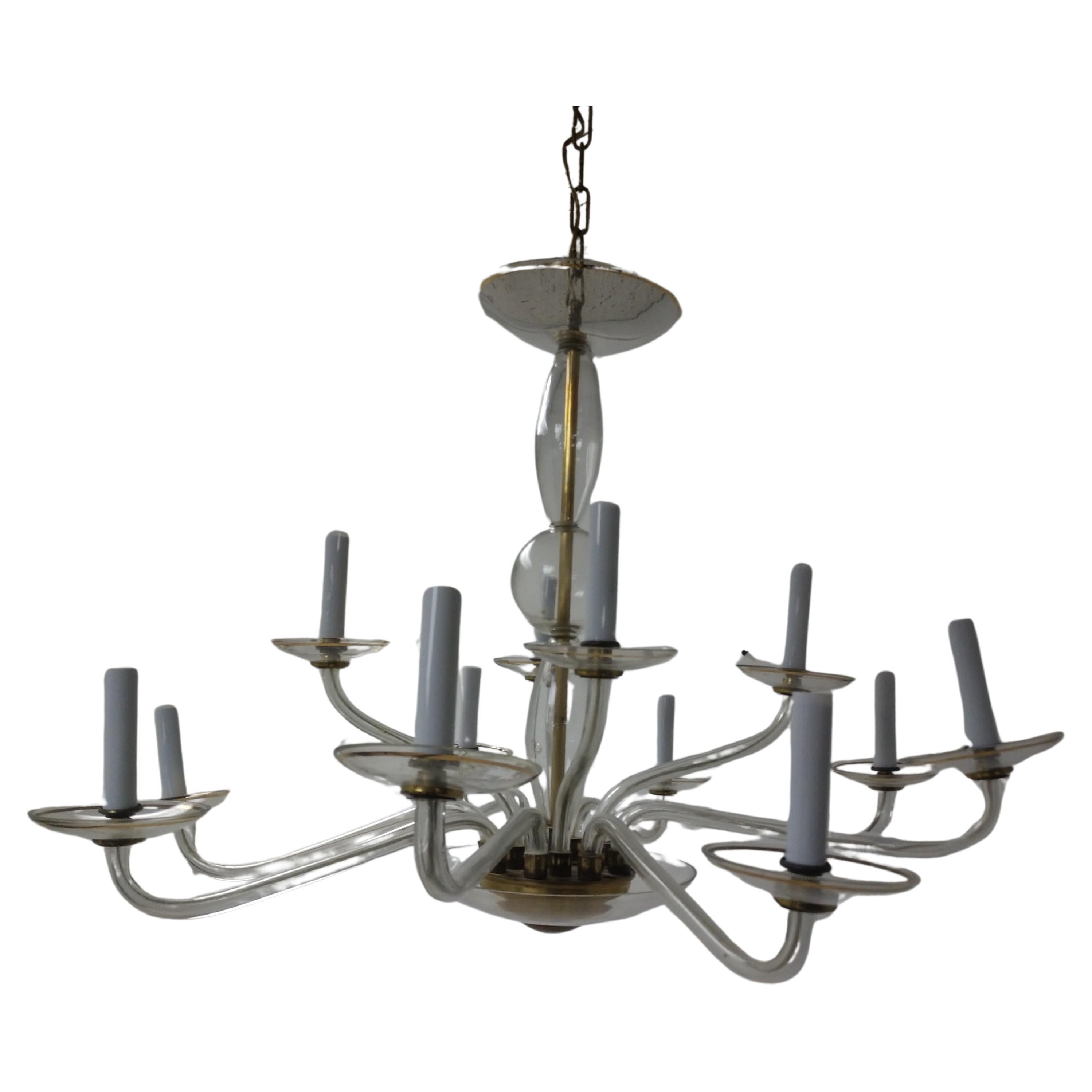 Beautiful and Classic in style 12-arm glass with brass accents chandelier. Elegant and simple 2 tiers of lighting, 4 up top and 8 below. In excellent vintage condition with minimal wear. Sound wiring.