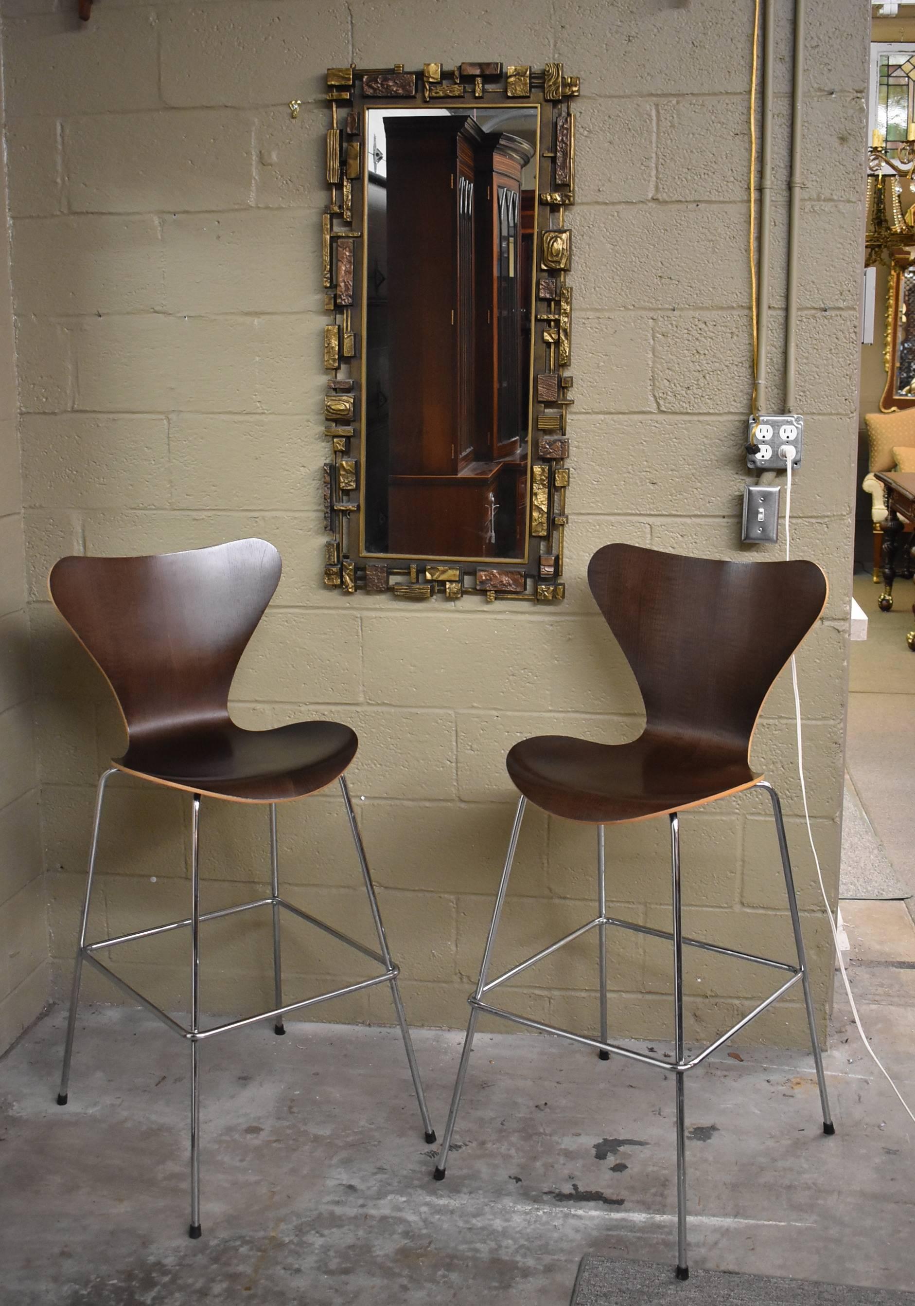 Stunning pair of midcentury Danish modern barstools designed by Arne Jacobsen for Fritz Hansen. They are done in a beautiful rich ebonized bent wood seat and back with a chrome frame. Very sturdy and in very good condition with normal light wear.