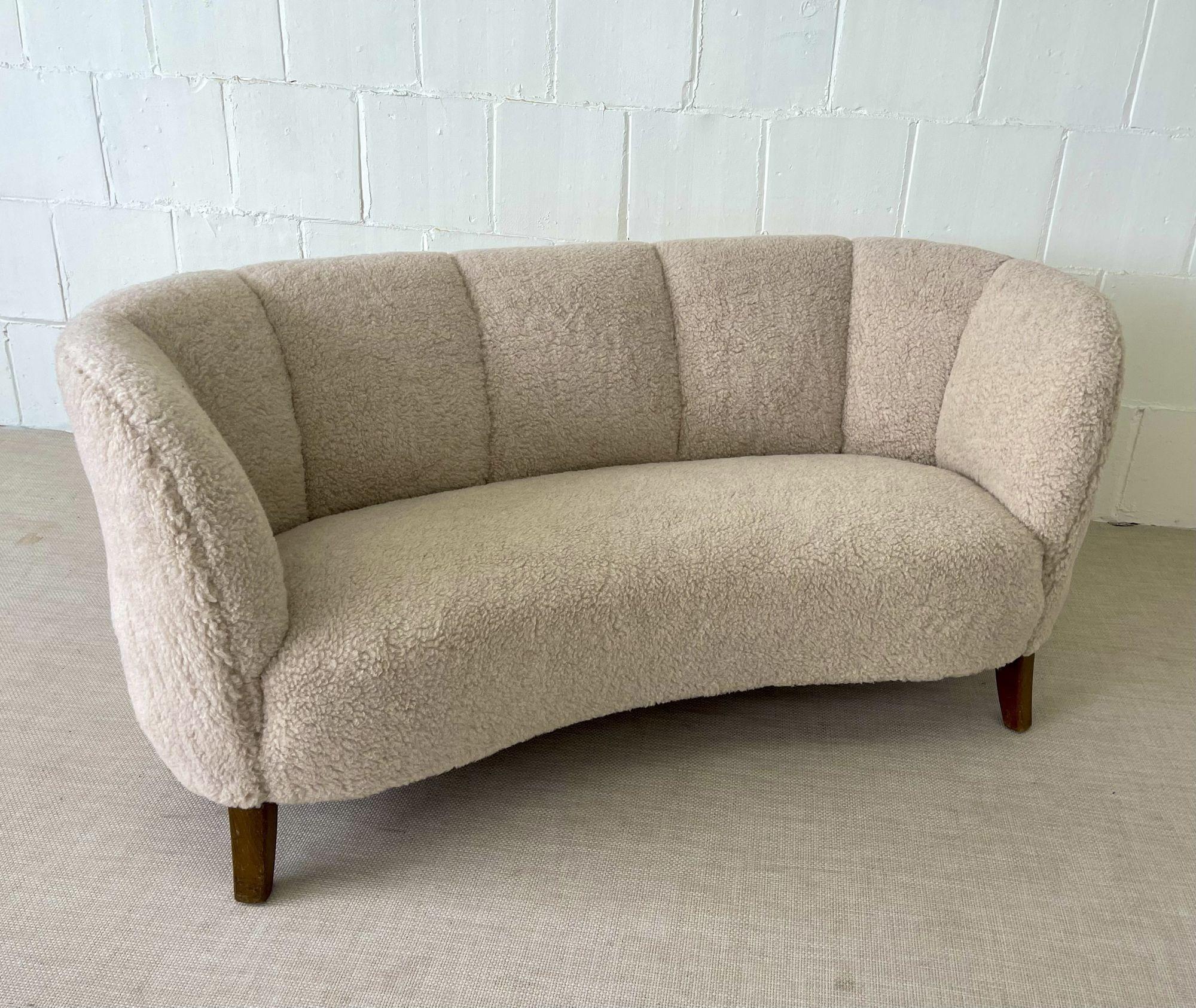 Mid-Century Modern Danish cabinet maker sofa / settee two-seater, lambswool
 
Newly upholstered in genuine lambs wool, this curved danish sofa, settee or loveseat has a beautiful freeform, organic shape. Oak legs and original undercarriage - this