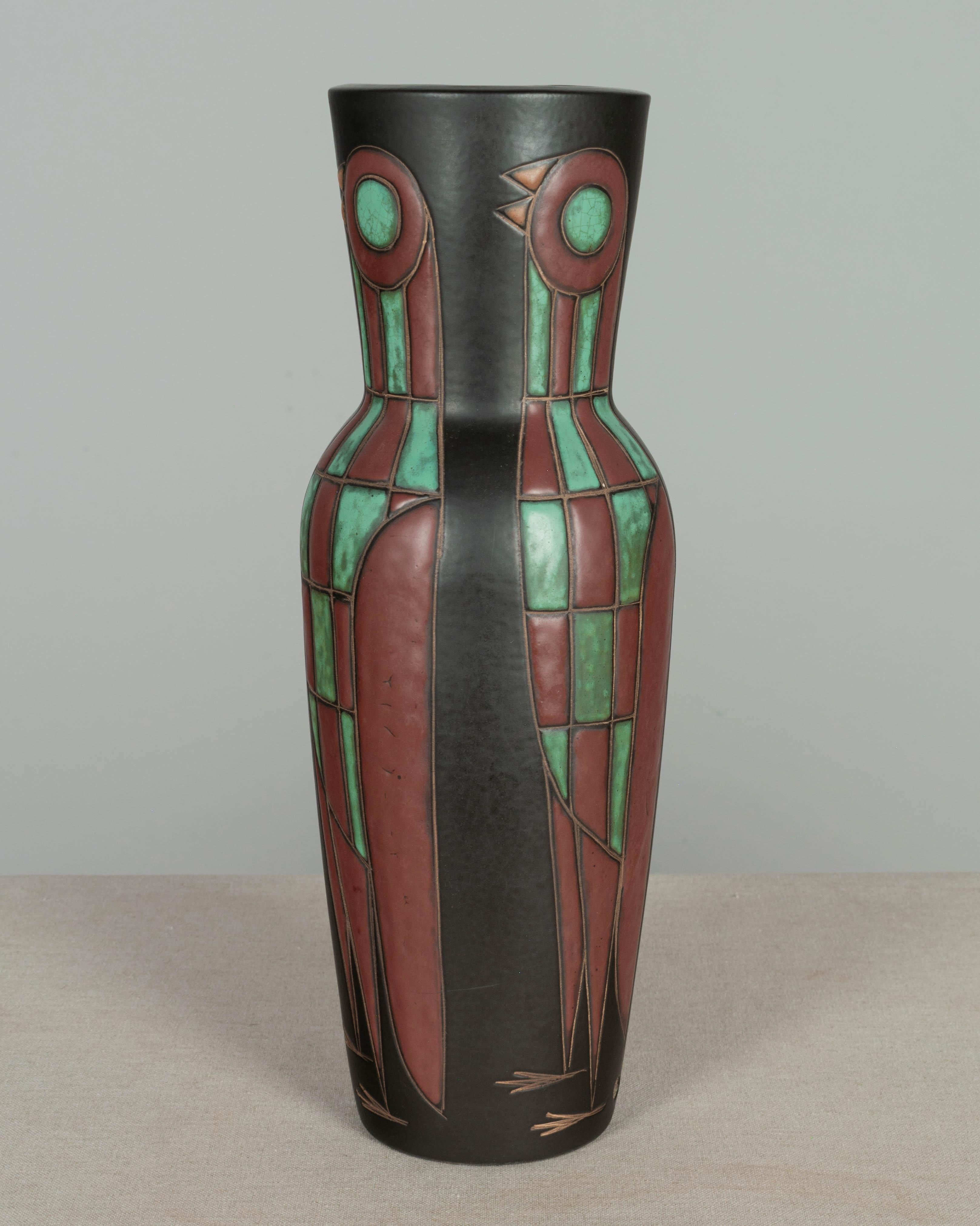 A Mid Century Danish Modern Marianne Starck for Michael Andersen & Sons art pottery lamp base. Tapered vase form with stylized birds in green, rust and orange on black ground with matte glaze. Hole in bottom so that it may be made into a lamp, but